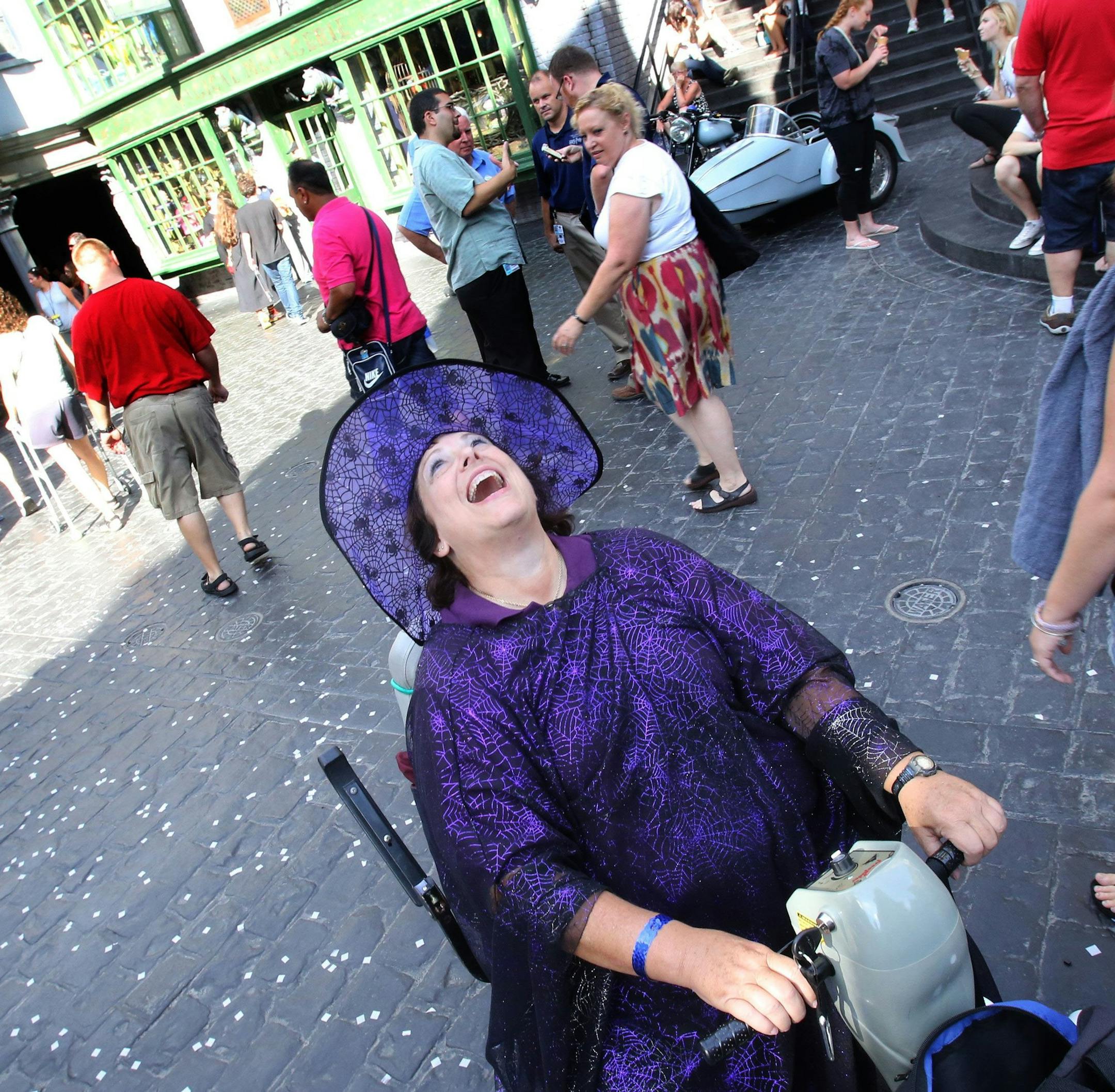 Brenda Ellis, of Melbourne, delights at being Diagon Alley during the grand opening at the Wizarding World of Harry Potter expansion, at Universal Studios Florida, in Orlando, Tuesday, July 8, 2014. (Joe Burbank/Orlando Sentinel/MCT)