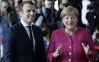 New French President Emmanuel Macron is welcomed by German Chancellor Angela Merkel in Berlin Monday, May 15, 2017, during his first foreign trip afte