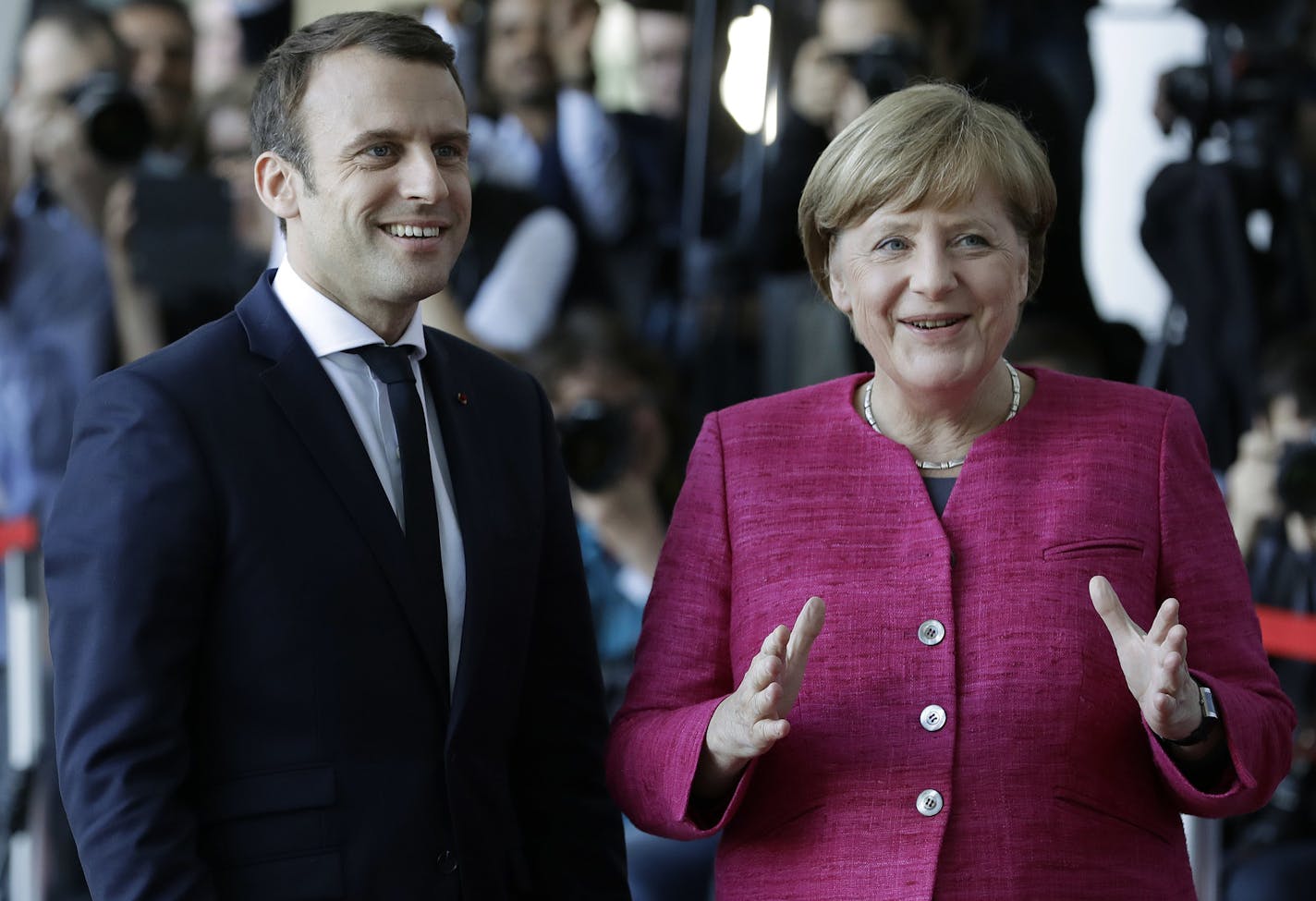 New French President Emmanuel Macron is welcomed by German Chancellor Angela Merkel in Berlin Monday, May 15, 2017, during his first foreign trip after his inauguration the day before. (AP Photo/Michael Sohn)