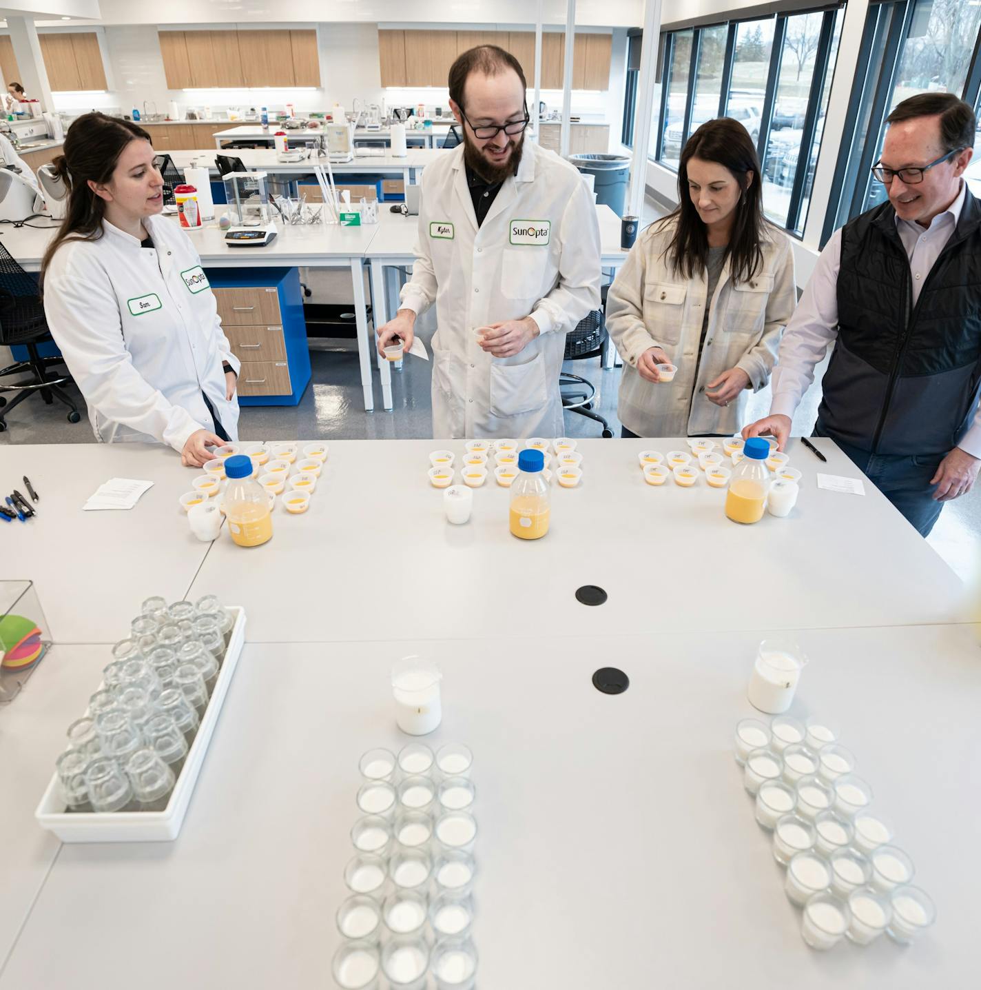 SunOpta CEO Joe Ennen, right, watched as food scientists evaluated  samples of a pumpkin oat beverage, Tuesday, March 29, 2022, Eden Prairie, Minn.   ] GLEN STUBBE • glen.stubbe@startribune.com