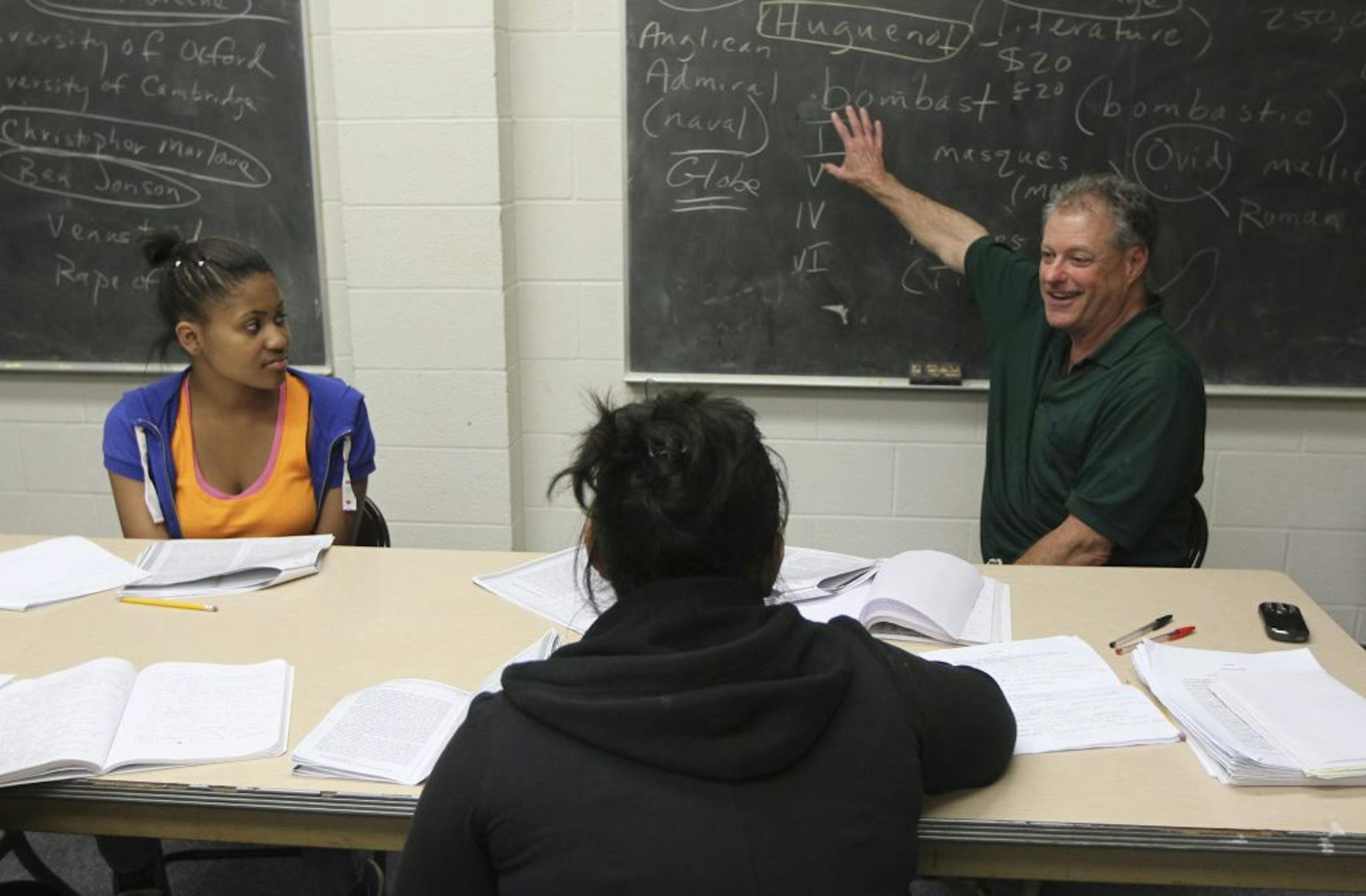 Gary Davison talked about who the Huguenots were as he discussed Shakespeare with ninth-graders Angelic Brown-Skinner, 14, left, and Olimpia Pineda, 15, at New Salem Baptist Church in Minneapolis.