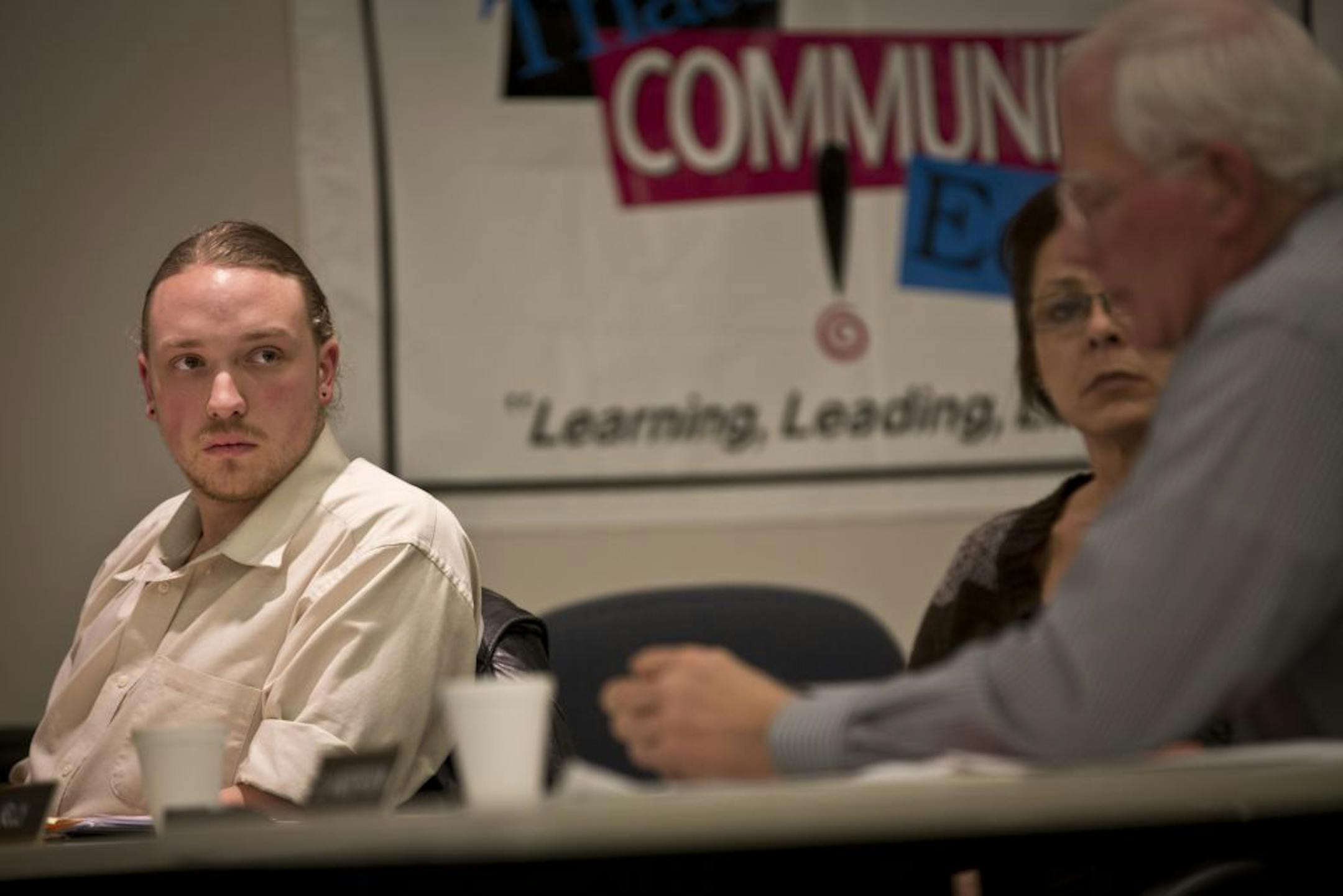 School board member Matt Rustad, who had admitted to plagiarizing work in a school newsletter, listened to other board members talk about removing him Monday night in St. Francis.
