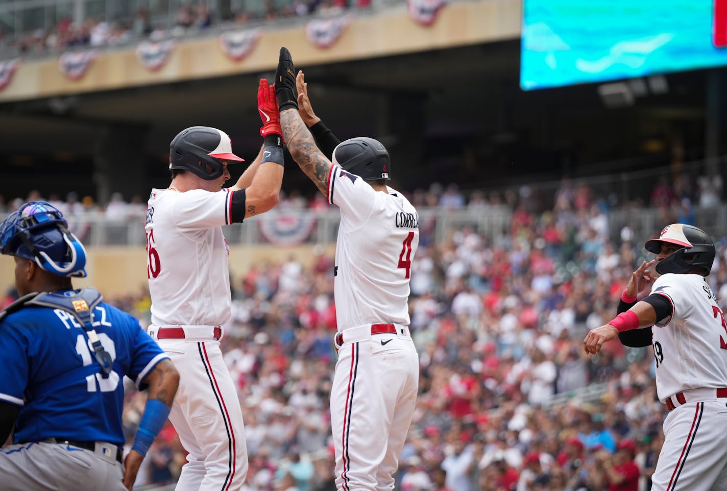 Minnesota Twins shortstop Carlos Correa (4) and Minnesota Twins second baseman Donovan Solano (39) celebrate with Minnesota Twins right fielder Max Kepler (26) as he crosses home plate after hitting a three-run home run in the third inning. The Minnesota Twins hosted the Kansas City Royals at Target Field on Tuesday, July 4, 2023 in Minneapolis. ] RENEE JONES SCHNEIDER • renee.jones@startribune.com