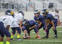 In this photo provided by USA Football, youth football teams in Solon, Ohio, play Rookie Tackle, a small-sided version of the sport piloted by USA Foo
