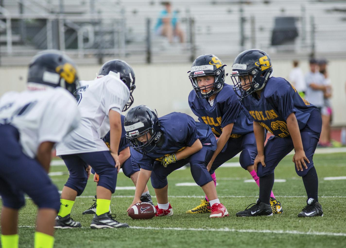 In this photo provided by USA Football, youth football teams in Solon, Ohio, play Rookie Tackle, a small-sided version of the sport piloted by USA Football in 2017, in alignment with the U.S. Olympic Committee's American Development Model for skill development and enjoyment of sport. Part of USA Football's mission is to make the game safer and more popular for youngsters. (Joe Smithberger/USA Football via AP)