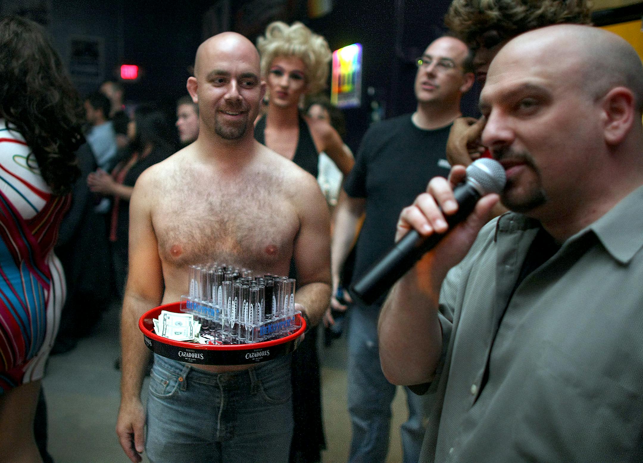 TOM WALLACE � twallace@startribune.comAssign:#00005083A slug: night1010 October 4, 2008 The expansion of gay bar Innuendo St. Paul will make it the only dance club in the sleepy downtown area. It celebrates with a grand opening party Friday.Sean Fetterman introduces Alaex Zachary, who was selling shots for charity during the Grand opening celebration.