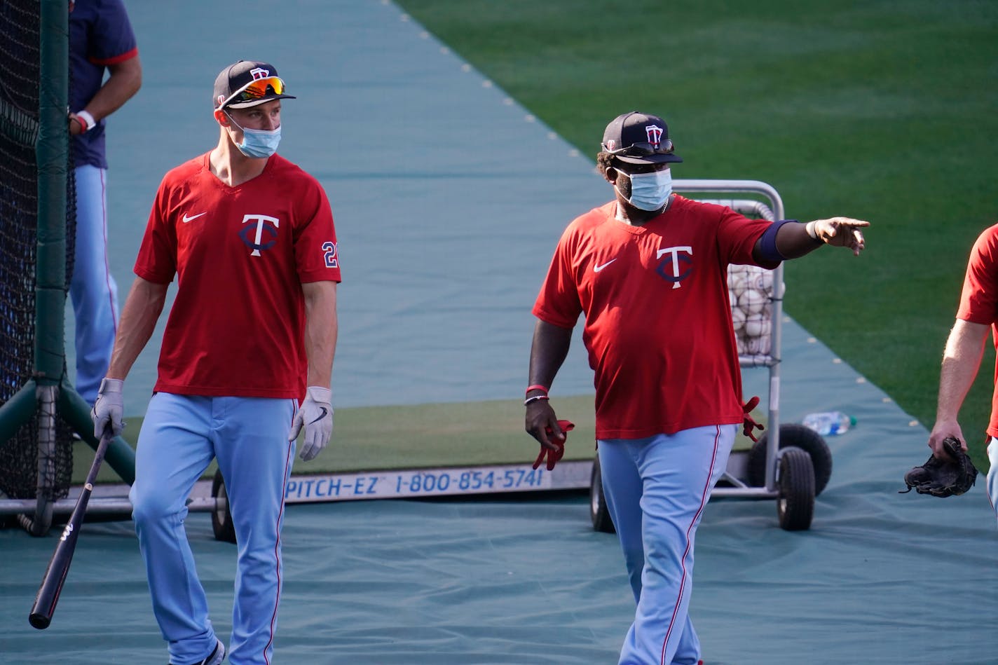 Twins players wear masks during batting practice amid the COVID-19 pandemic, before a game against the Angels on Friday