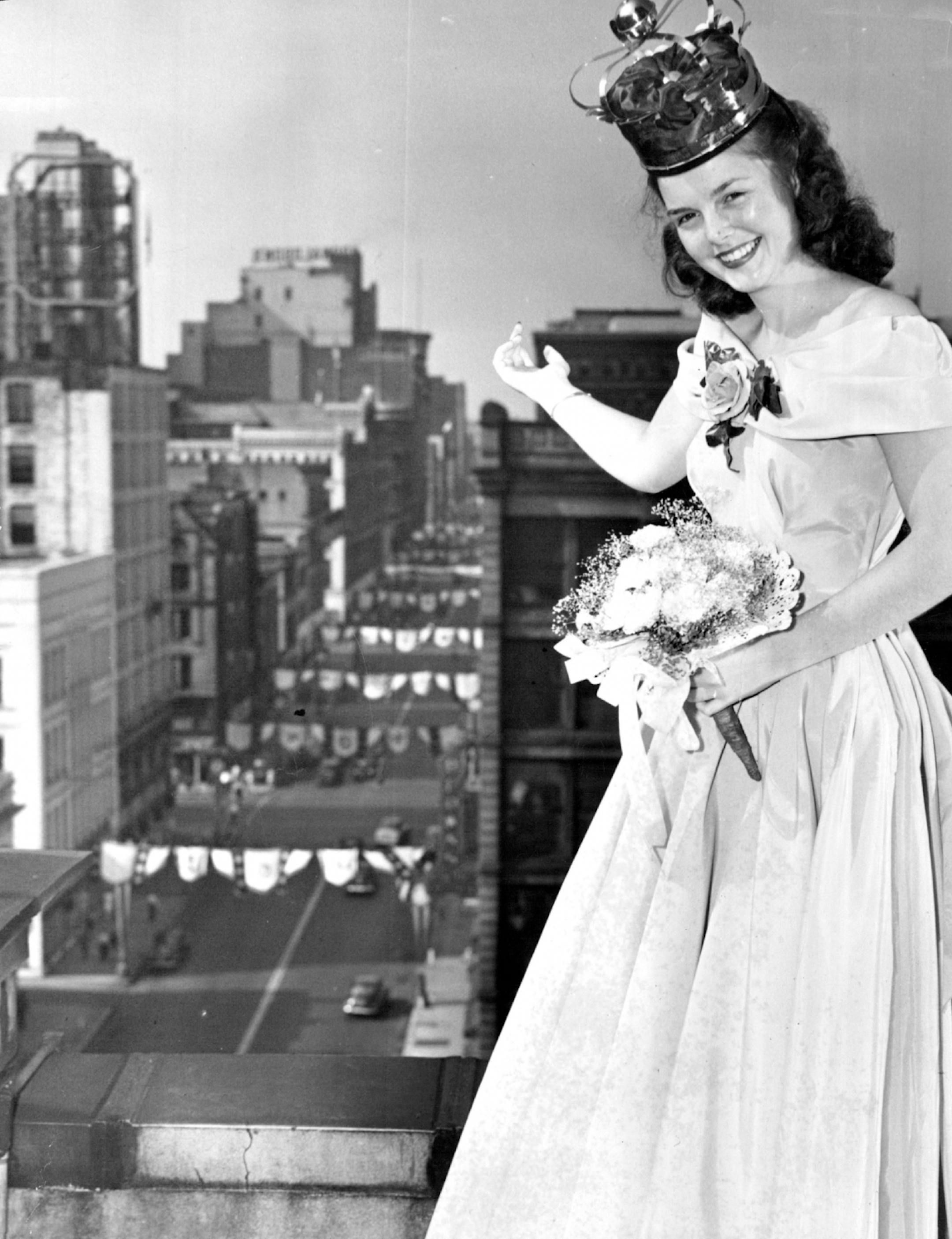 July 26, 1947: Newly crowned Aquatennial Queen McLane stands atop the Nicollet hotel looking over the downtown district of the city that will be hers for a one-year reign.