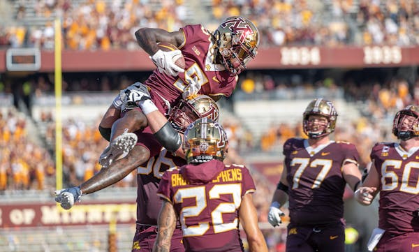 Gophers wide receiver Dylan Wright (5) celebrated with teammates after a touchdown against Colorado on Saturday at Huntington Bank Stadium.