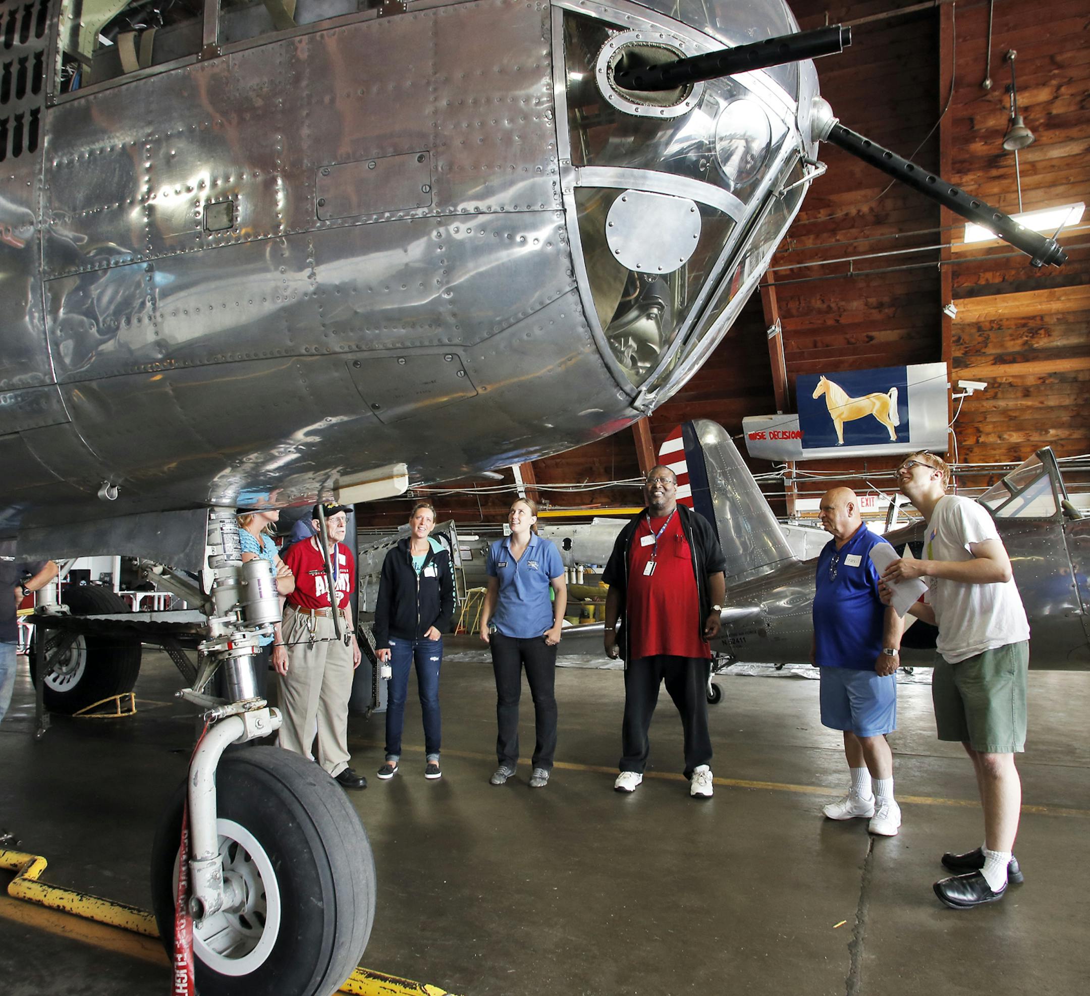 Genuine Genius is a program designed to promote the talents of people with autism. One of the individuals in the program is Ricky Whitmore, 25, who has an interest in aviation history. He recently led a group of men from the Veterans Home in Minneapolis in a tour through the Commemorative Air Force Museum in South St. Paul, reading from a prepared text as they viewed vintage war planes and vehicles. Whitmore, right, pointed out aviation details to the group. (MARLIN LEVISON/STARTRIBUNE(mlevison@