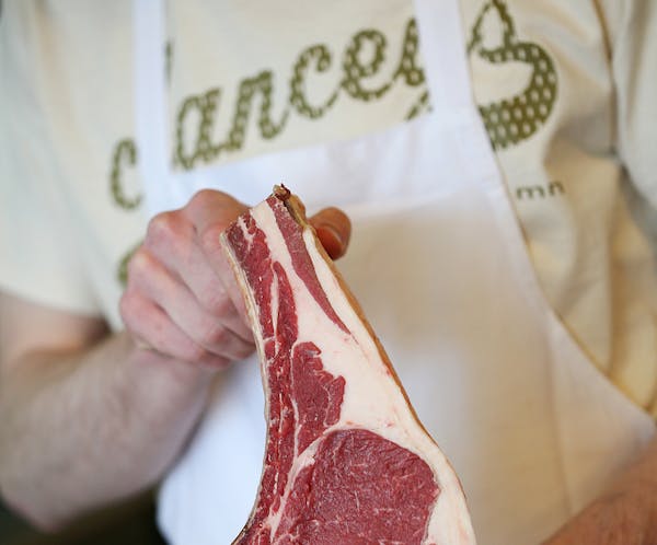 Alexander Huffington holds a ribeye at Clancey's Meats and Fish in Linden Hills May 12, 2013. (Courtney Perry/Special to the Star Tribune)