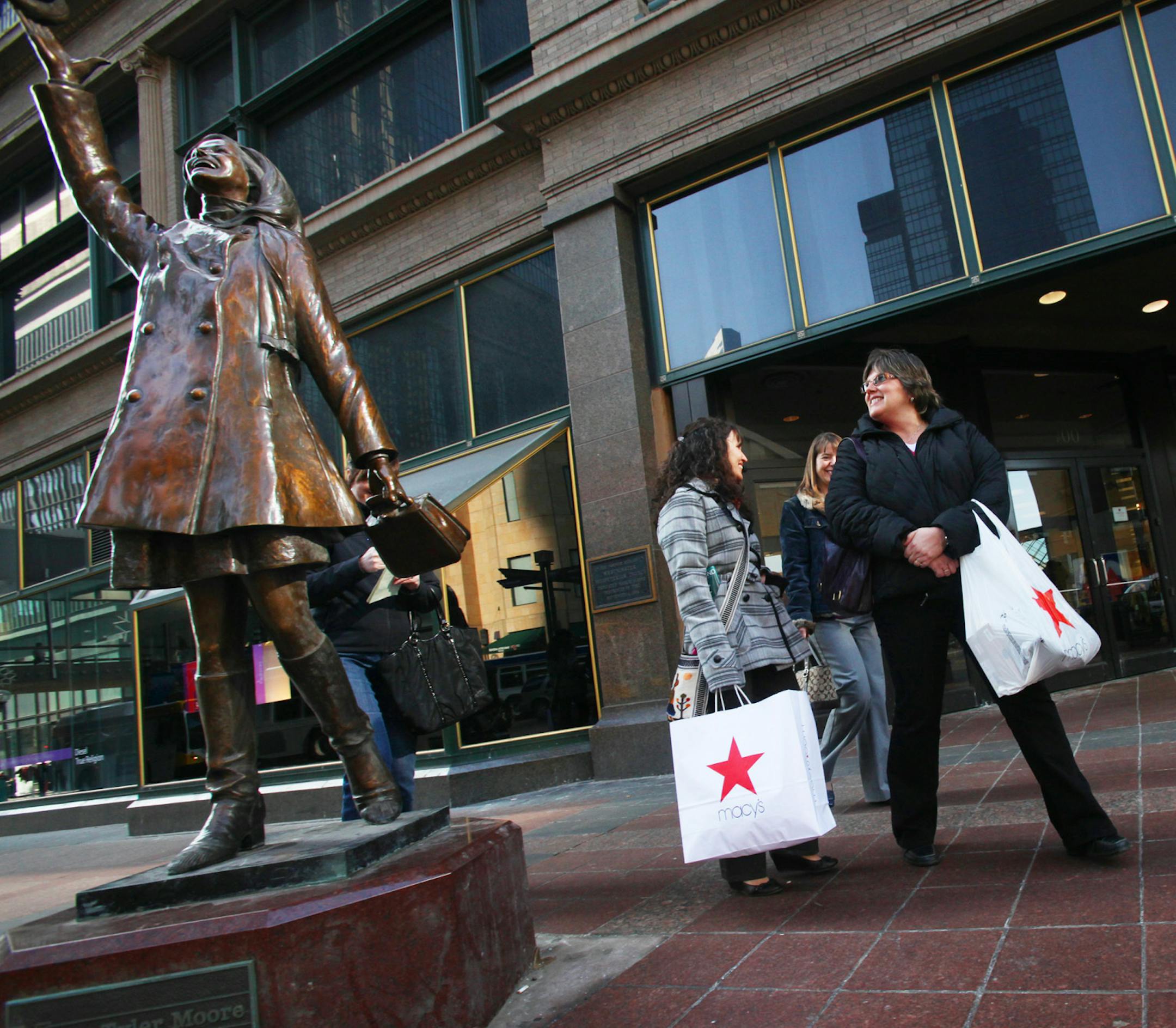 RENEE JONES SCHNEIDER • reneejones@startribune.com Minneapolis, Minn. - 3/4/10 - February sales were up four points at Macys. IN THIS PHOTO] From the left, Britt Qualley, Dawn Maine, and Susan Wiger, all teachers from Brainard visiting the Twin Cities for a conference, pointed out the Mary Tyler Moore statue after leaving Macy's where they shopped the sales Thursday.