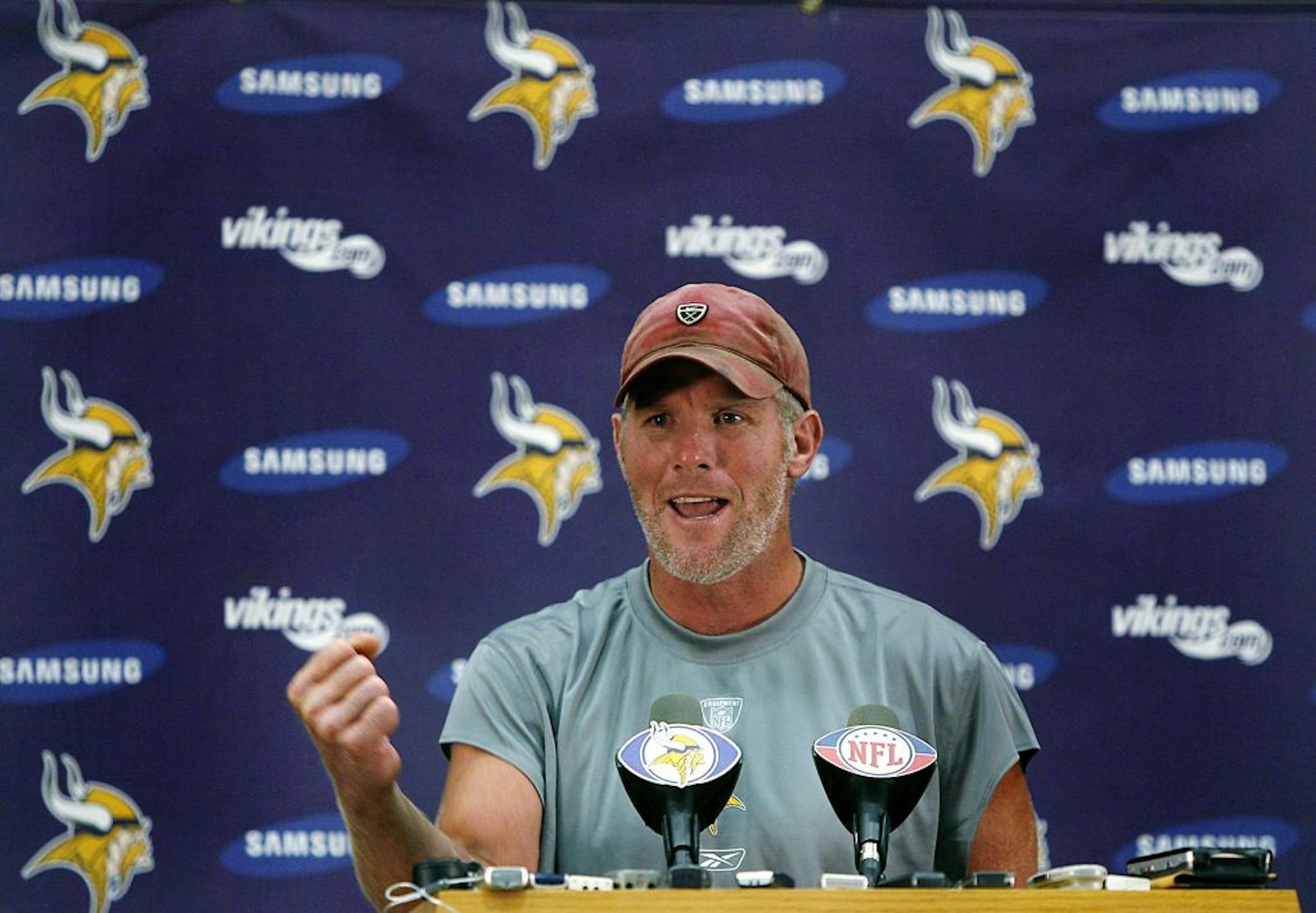 Quarterback Brett Favre pumps his fist after telling a story about how his players took the news of him coming to the Minnesota Vikings, during a news conference at the NFL football team's training facility Tuesday, Aug. 18, 2009, in Eden Prairie, Minn.