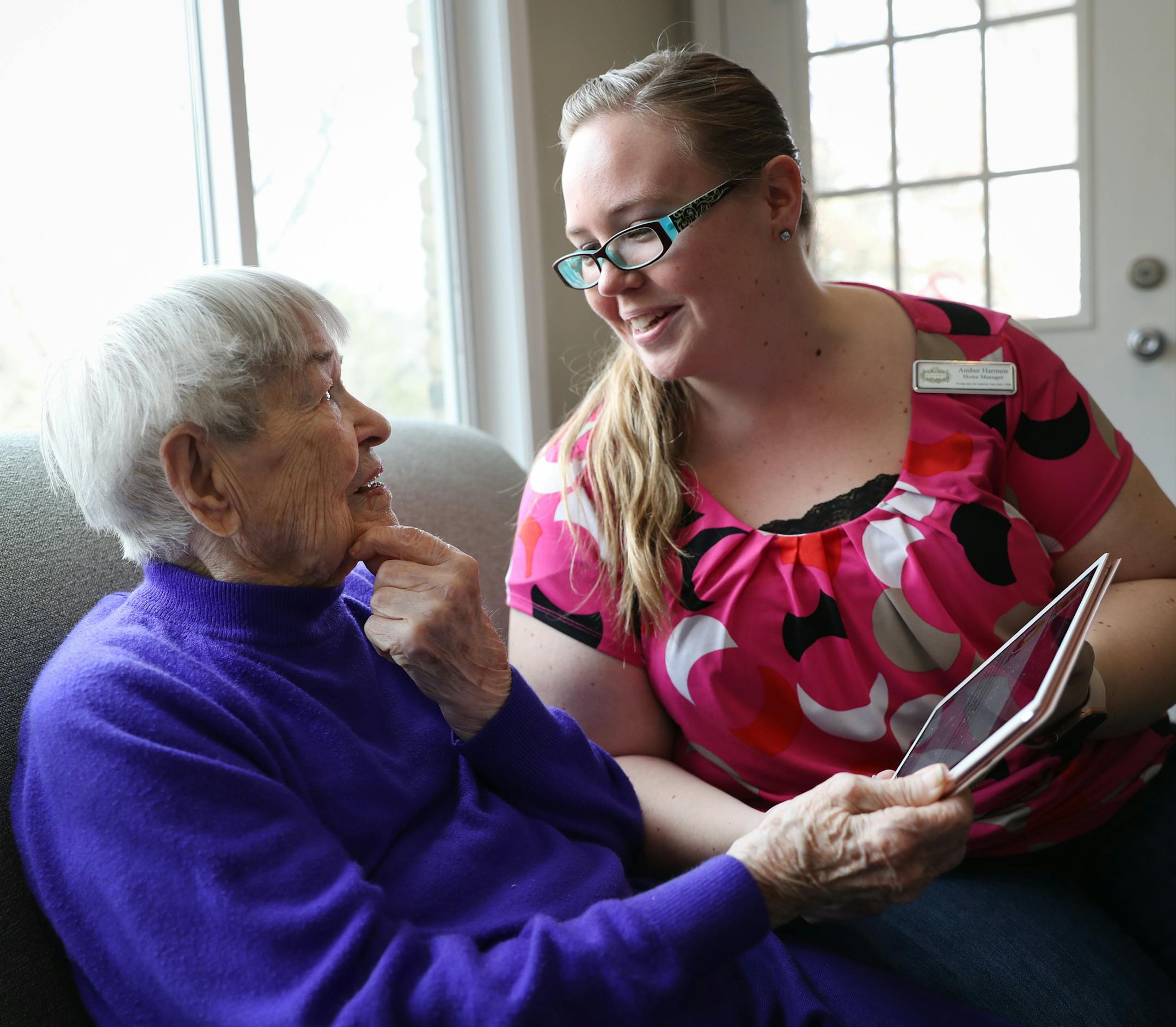 Amber Harmon, manager at Rakhma Harmony Home in Golden Valley, shared a personalized show of memories and photos with 94-year old Mary Surleta. ] Shari L. Gross • shari.gross@startribune.com At Rakhma Harmony Home, an assisted living residence in Golden Valley, manager Amber Harmon has has been trained to use the House of Memories iPad app and share with residents who have memory challenges.
