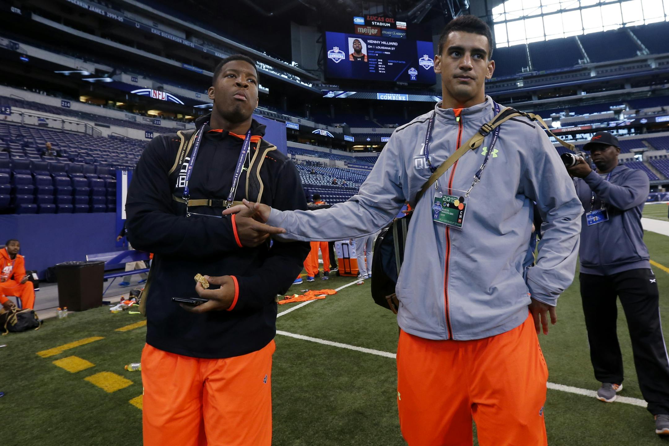 Florida State quarterback Jameis Winston, left, walks with Oregon quarterback Marcus Mariota after participating at the NFL football scouting combine in Indianapolis earlier this year.
