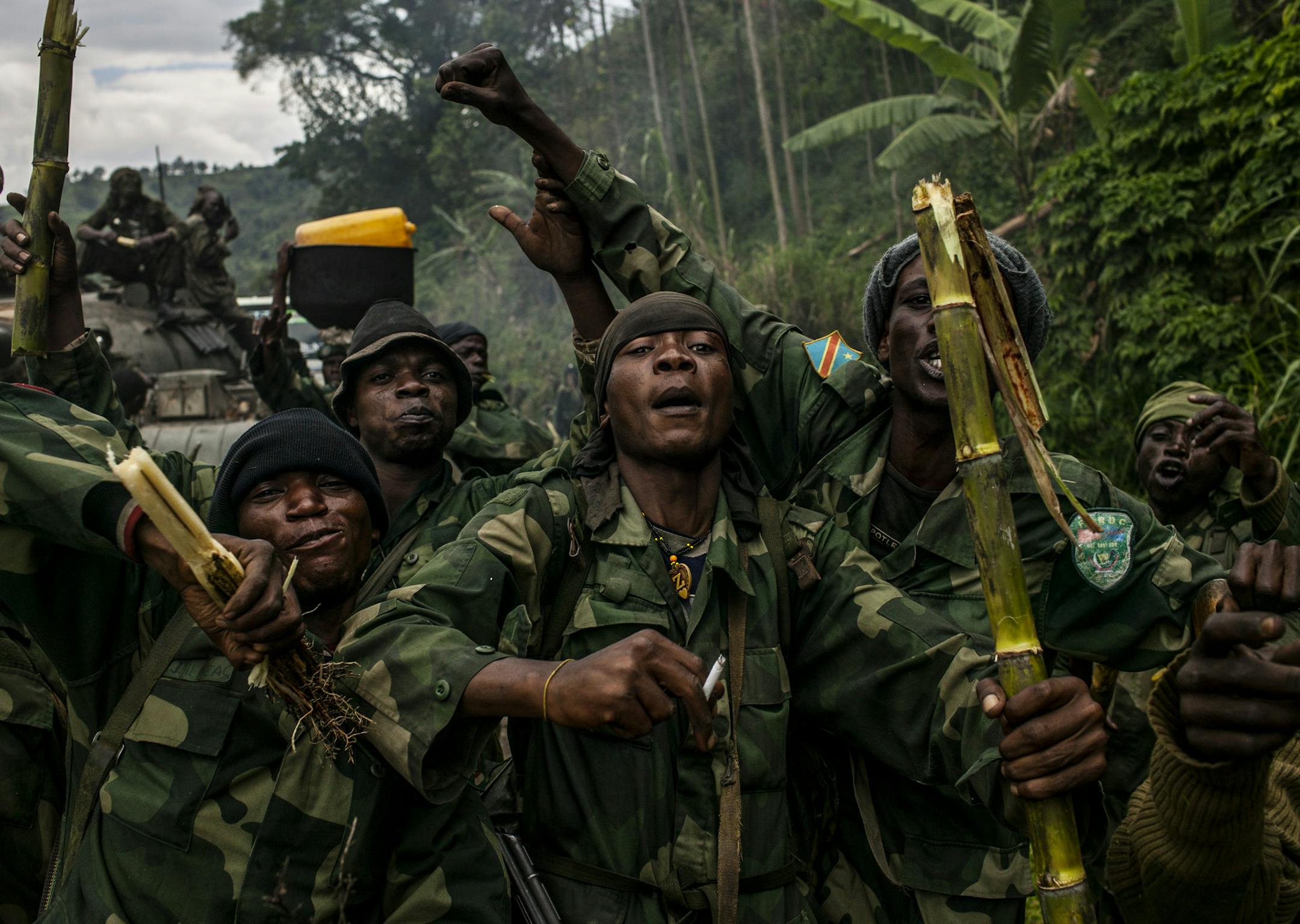 Congolese commandos celebrate as they advance up the mountainous road toward Bunagana, the last remaining stronghold of the M23 rebels, Oct. 30, 2013. The feared rebel group in the Democratic Republic of Congo, M23, announced Tuesday, Nov. 5, 2013, that it was laying down its arms immediately, in a major development that held out hope of a new era of peace and stability in the violence-wracked region. (Pete Muller for the New York Times)