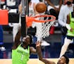 Minnesota Timberwolves forward Anthony Edwards (1) was fouled on his way to the rim by Portland Trail Blazers forward Derrick Jones Jr. (55) in the se