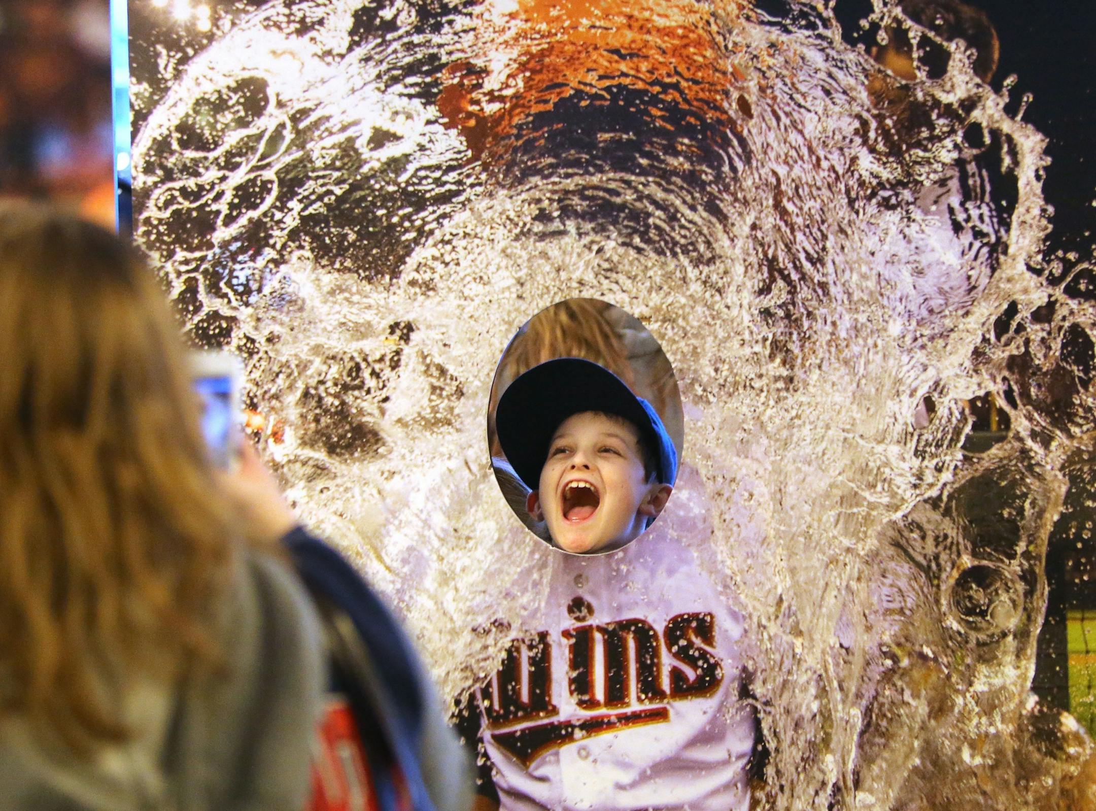 Twins fan Conner Tax, 8, of Watertown, MN, poses in a cut out of a Twins player taking a Gatorade bath while he gets his photo taken at Twinsfest, Friday, Jan. 29, 2016, at Target Field in Minneapolis, MN.