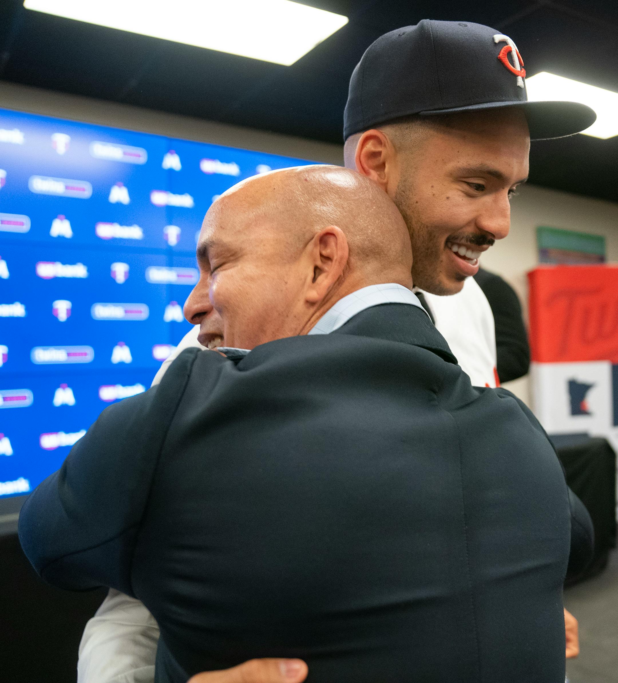 Minnesota Twins shortstop Carlos Correa embraces his father, Carlos Correa Sr., after a press conference.