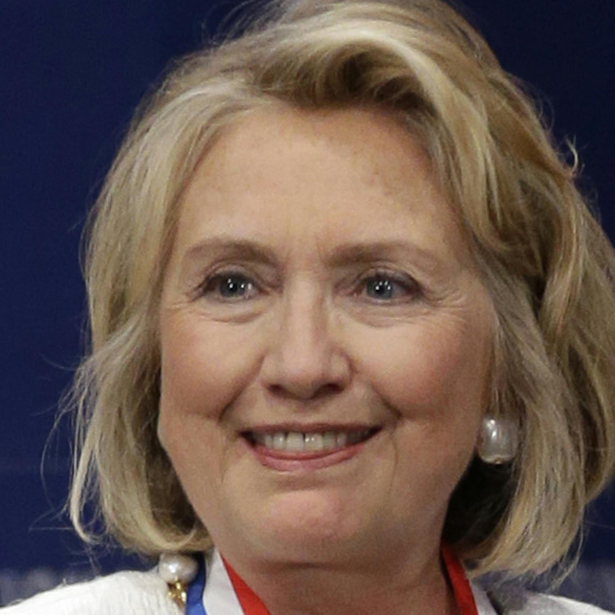 Former Secretary of State Hillary Rodham Clinton walks to the podium after receiving the Liberty Medal during a ceremony at the National Constitution Center, Tuesday, Sept. 10, 2013, in Philadelphia. The honor is given annually to an individual who displays courage and conviction while striving to secure liberty for people worldwide. (AP Photo/Matt Rourke)