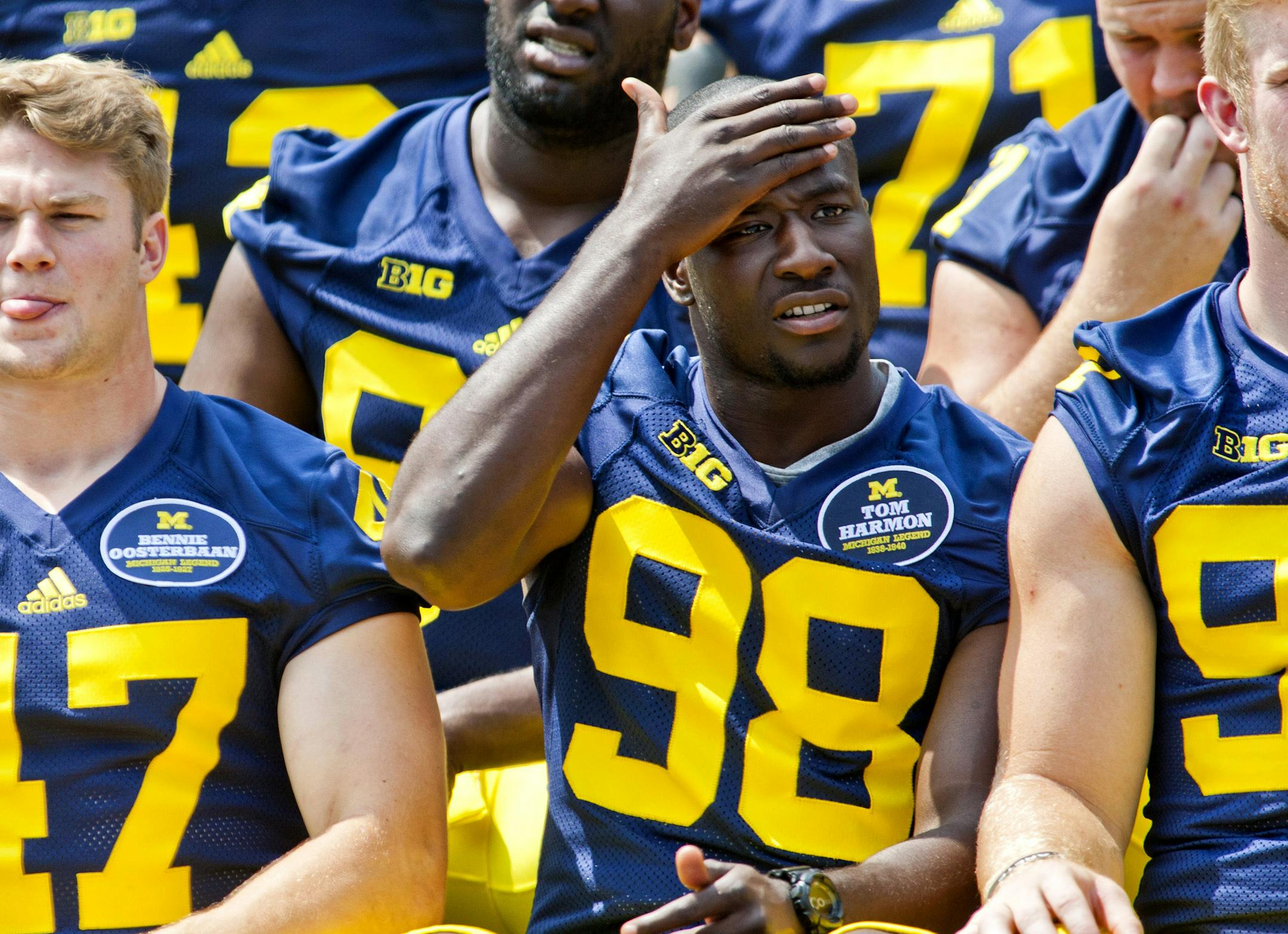 Michigan linebacker Jake Ryan (47), quarterback Devin Gardner (98) and teammates sit for a photo during the NCAA college football team's preseason media day, Sunday, Aug. 10, 2014, at Michigan Stadium in Ann Arbor, Mich. (AP Photo/Tony Ding)