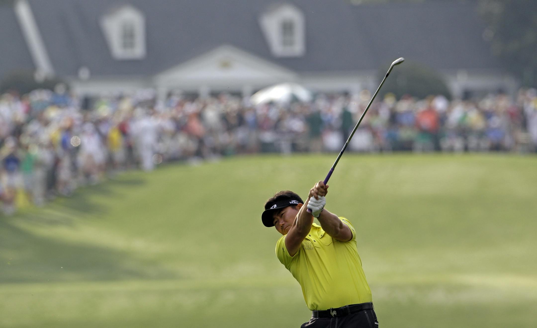 Y.E. Yang of Korea hits a shot on the first hole during the second round of the Masters golf tournament Friday, April 8, 2011, in Augusta, Ga.