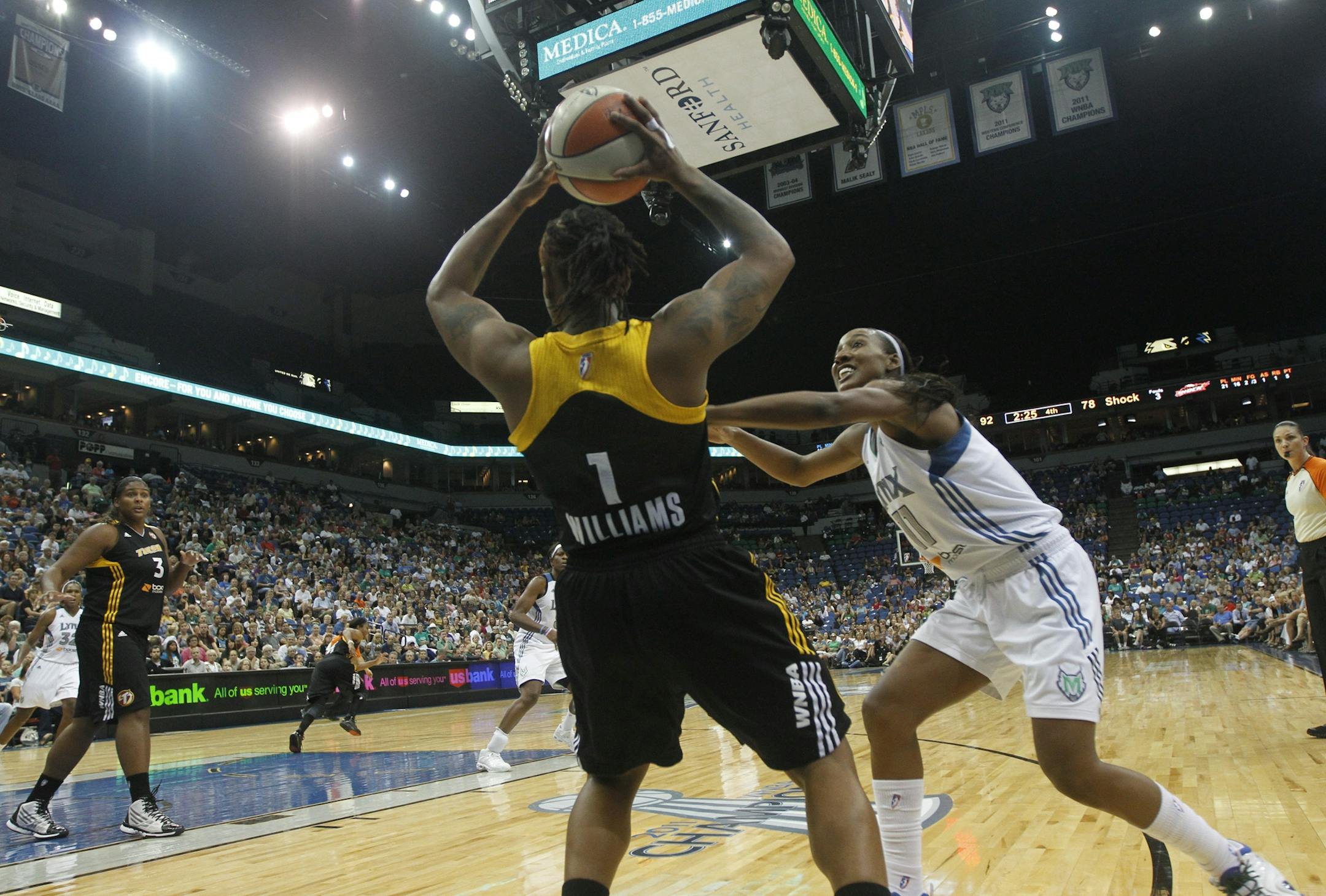 Lynx Candice Wiggins played close defense against Shock's Riquna Williams during second half action at the Target Center in Minneapolis, Min., Friday August 31, 2012. Lynx won over the Shock 92-83.