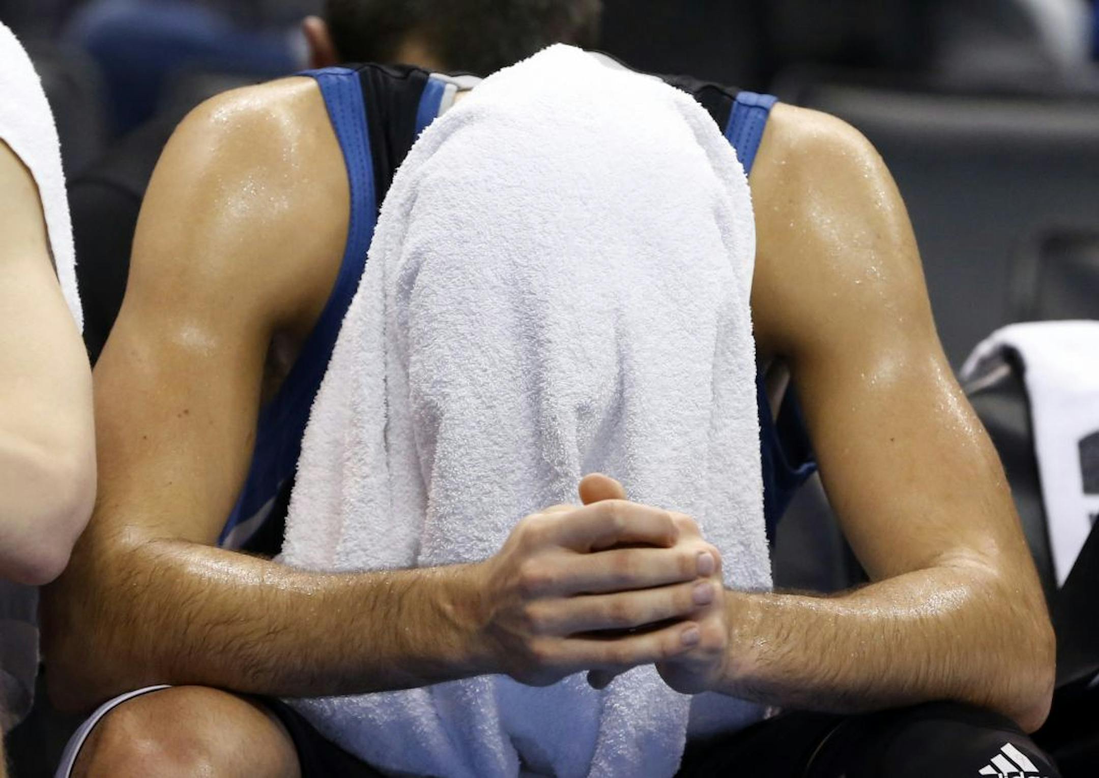 Ricky Rubio covers his head with a towel during the fourth quarter of a loss at Oklahoma City.
