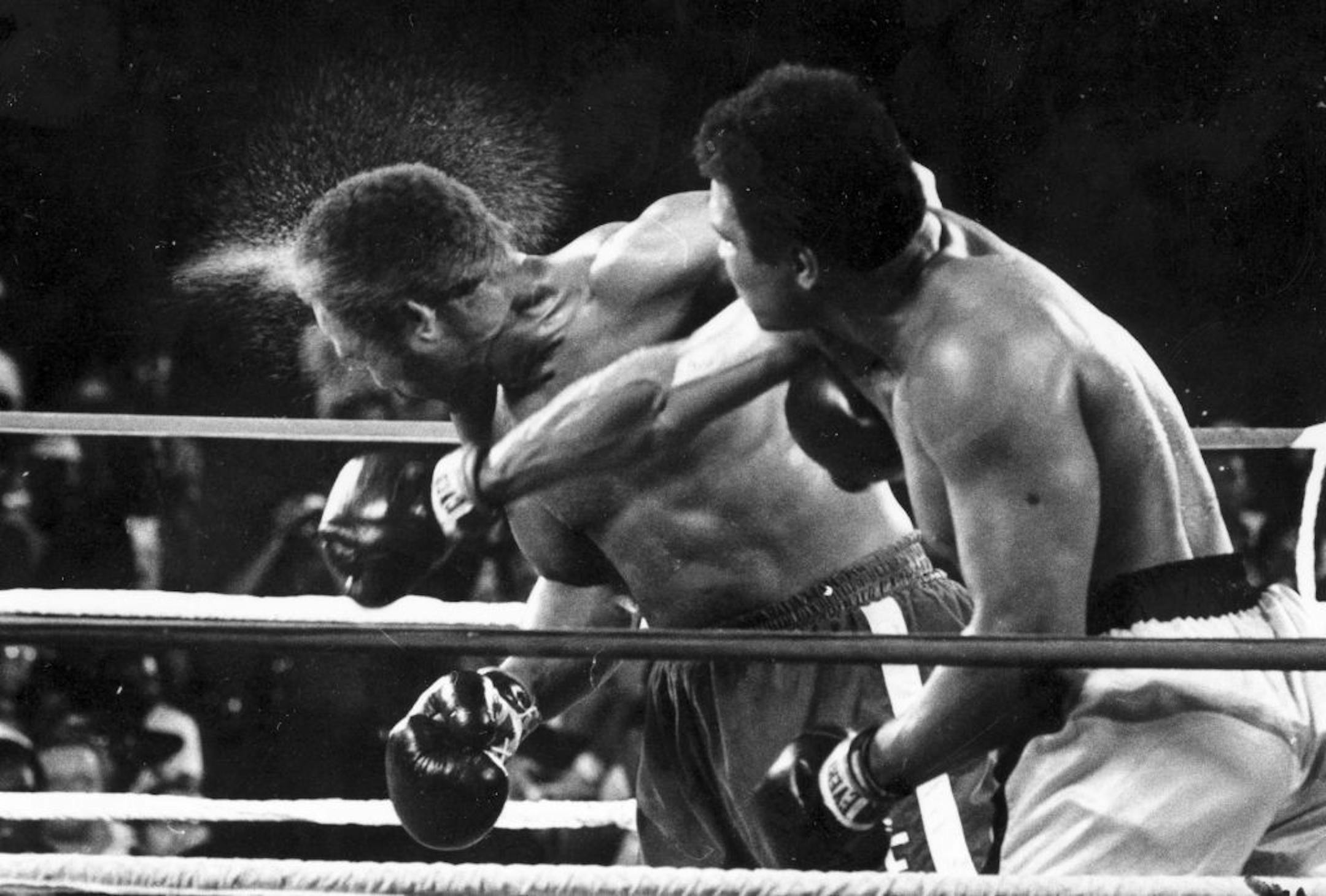 FILE - This is a Oct. 30, 1974, file photo showing George Foreman taking a right to the head from challenger Muhammad Ali in the seventh round in the match dubbed Rumble in the Jungle in Kinshasa, Zaire. Ali, the magnificent heavyweight champion whose fast fists and irrepressible personality transcended sports and captivated the world, has died according to a statement released by his family Friday, June 3, 2016. He was 74.
