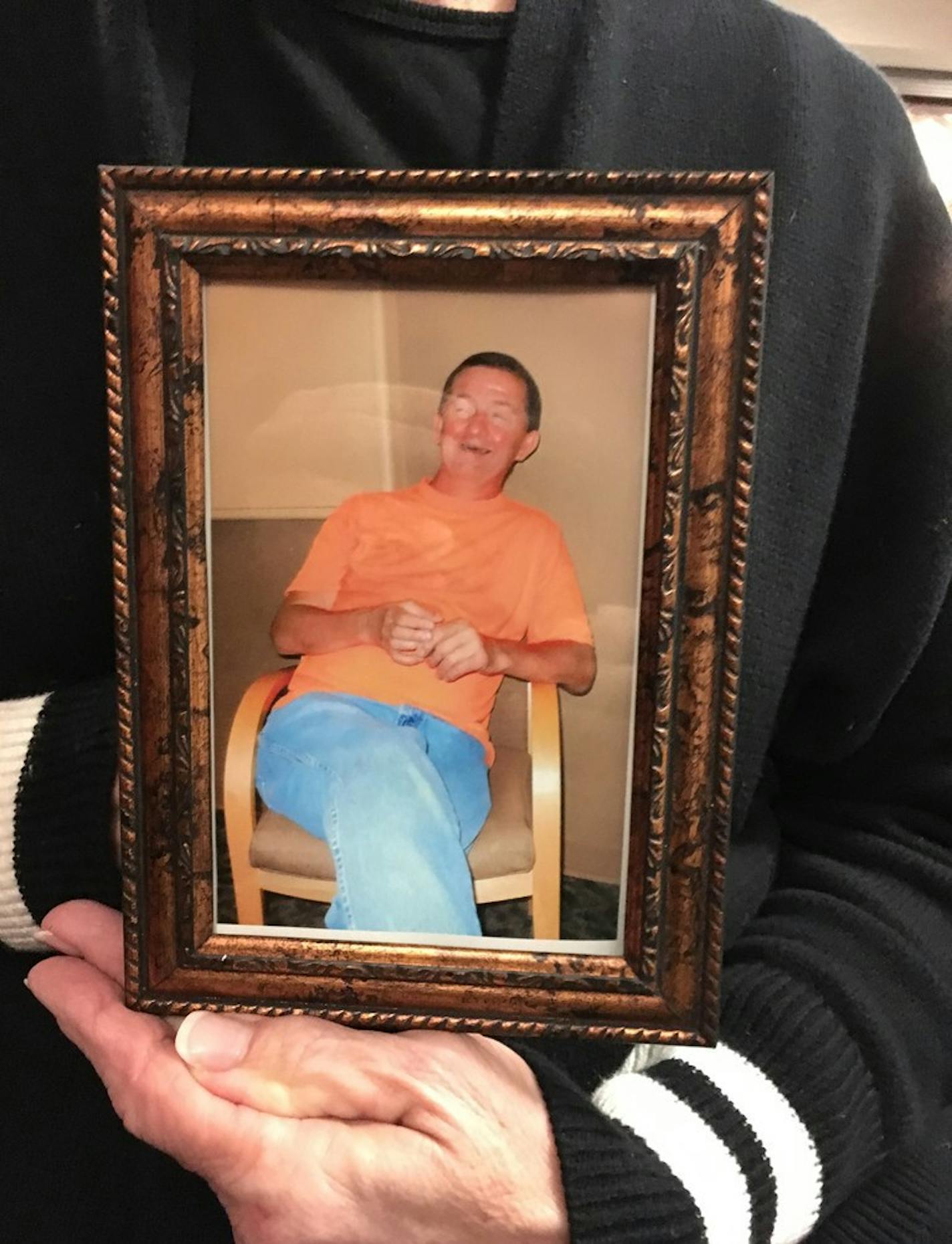 Connie Billmeier held a photo of her brother, Steven Nelson, 58, who had dementia and was confined to a wheelchair. State health investigators allege that Nelson died after he was brutally beaten by staff at an assisted-living facility in Hill City, Minn.