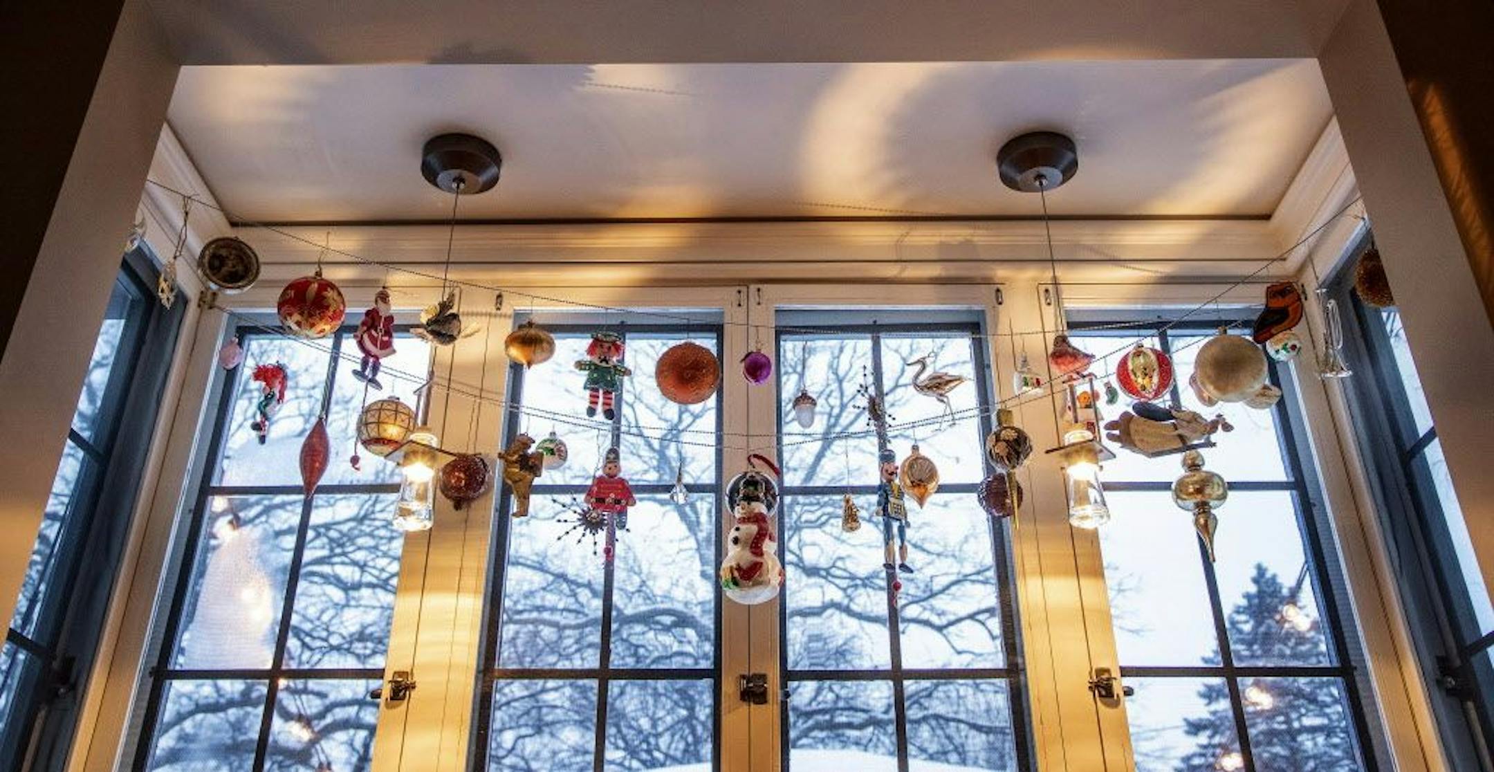 The homeowners' nostalgic ornaments strung across the kitchen window.
