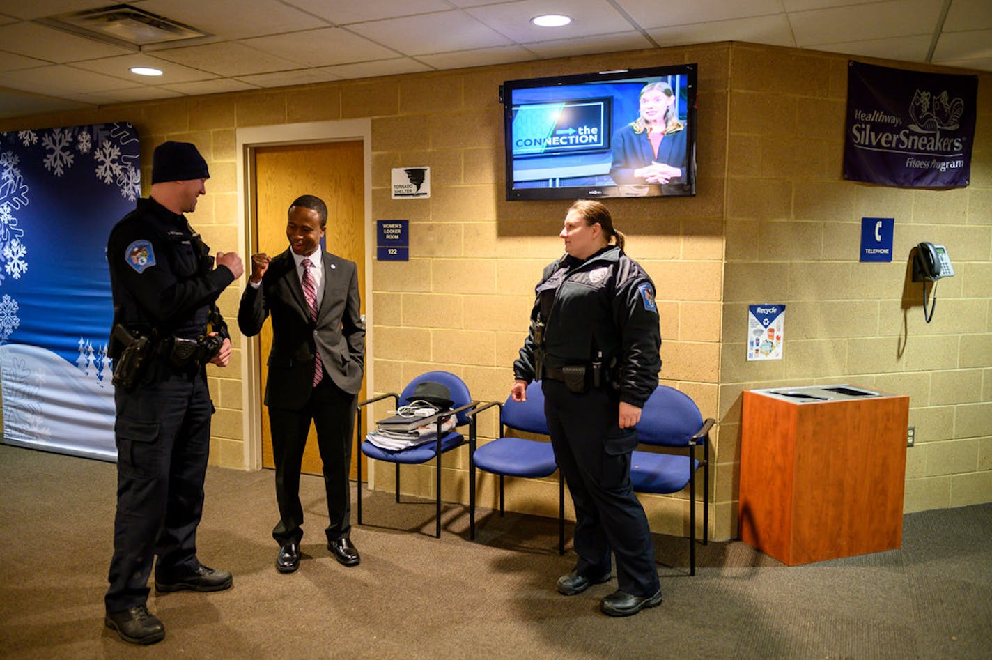 Brooklyn Center Mayor Mike Elliott greeted officers Josh Whittenburg and Alicia Johnson before Elliott's inauguration in 2019. The Joint Community Police Partnership improves communication between officers and the city's diverse residents.