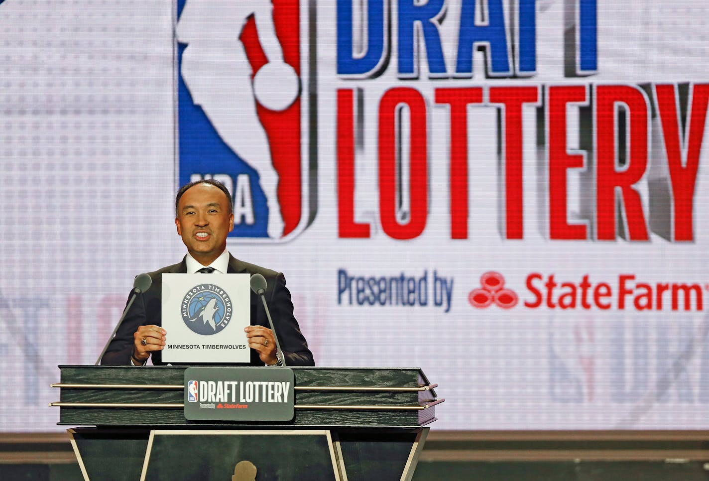 NBA Deputy Commissioner Mark Tatum announces that the Minnesota Timberwolves had won the eleventh pick during the NBA basketball draft lottery Tuesday, May 14, 2019, in Chicago. (AP Photo/Nuccio DiNuzzo)