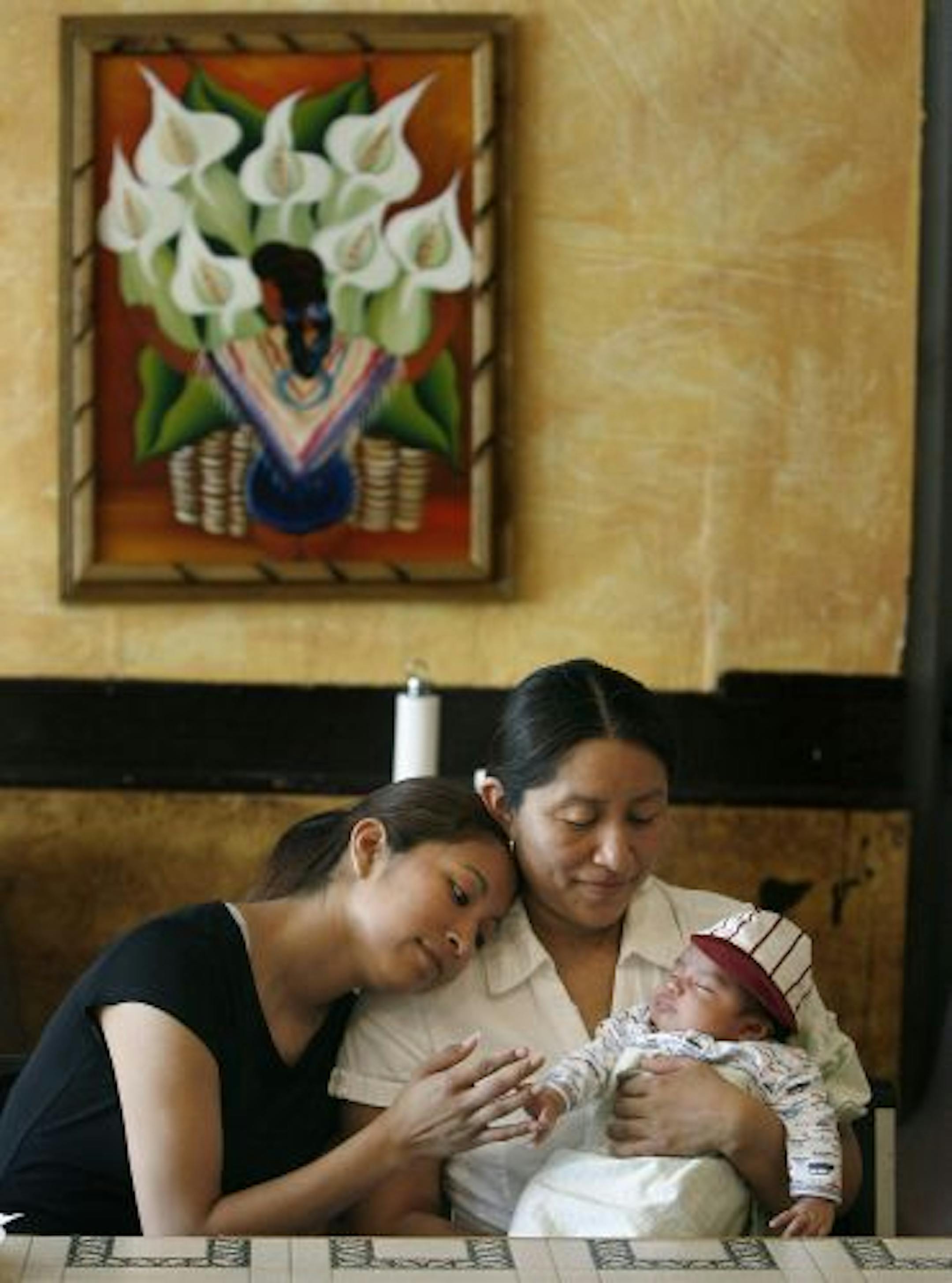 Quiet moments like these — Carmela Morales, 22, with her mother, Maria Elena Morales, and new brother Samuel — have been too frequent at the family's E. Lake Street restaurant.