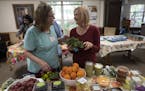 Volunteers Rita Kolodjski left, and Terri Jones sorted through foods donated by the East Side Neighborhood Services mobile food shelf at Bassett Creek