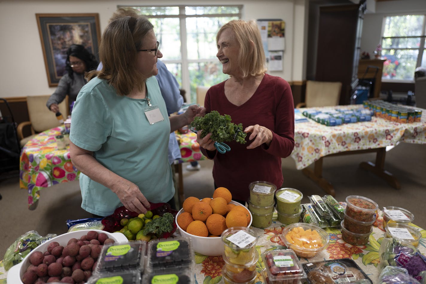 Volunteers Rita Kolodjski left, and Terri Jones sorted through foods donated by the East Side Neighborhood Services mobile food shelf at Bassett Creek Commons.] Jerry Holt &#x2022; Jerry.holt@startribune.com Half a dozen Twin Cities nonprofits that provide free food to low-income seniors say they will have to drastically cut back services if Hennepin County approves a $1 million cut in their funding. They say the county is shifting resources to child protection and cutting funding for food assis