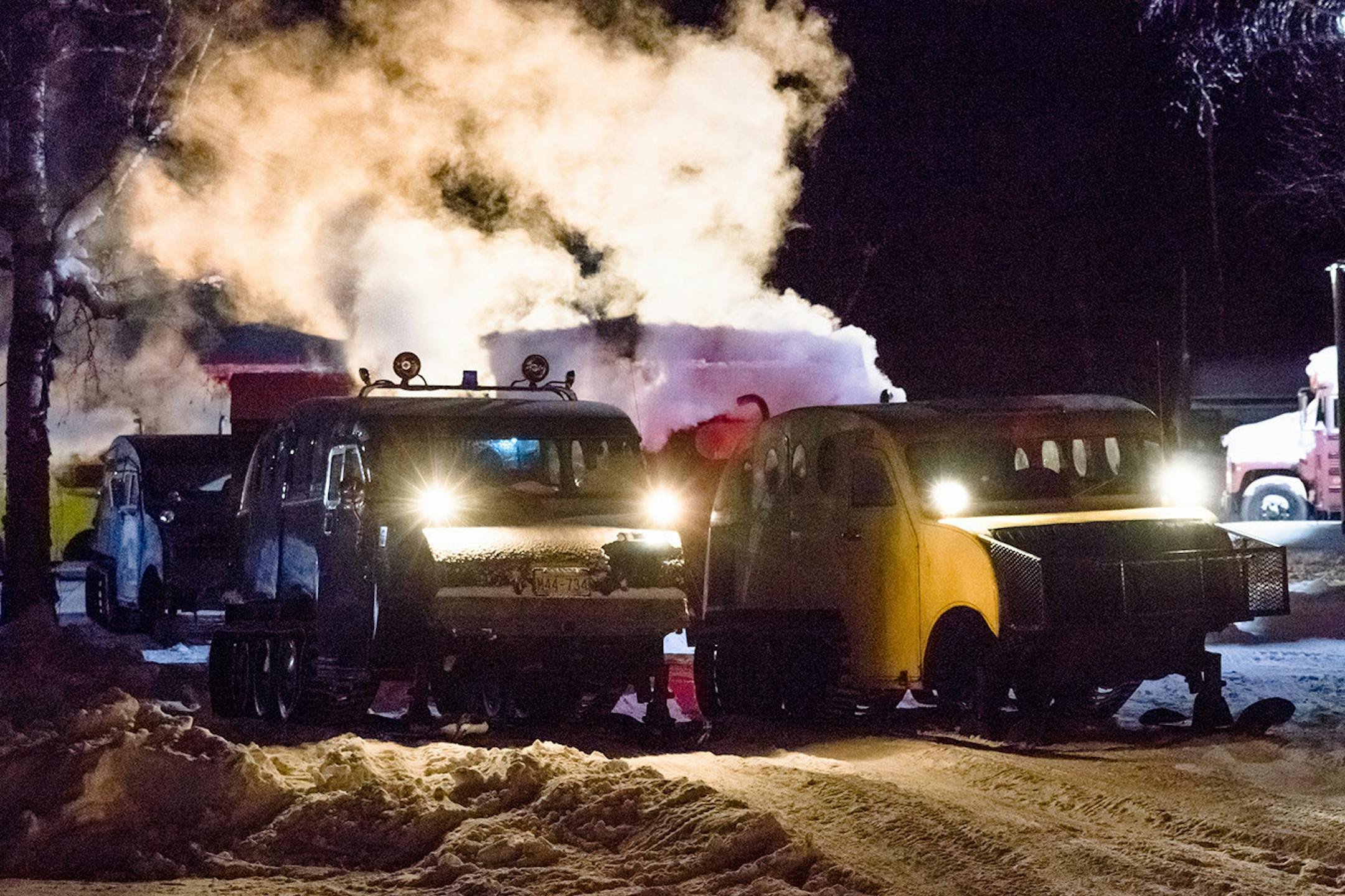 Ice guides line up their bombardiers for the morning commute to shuttle ice fishers onto the ice. They often start before sunrise and don't arrive back on land until after sundown.