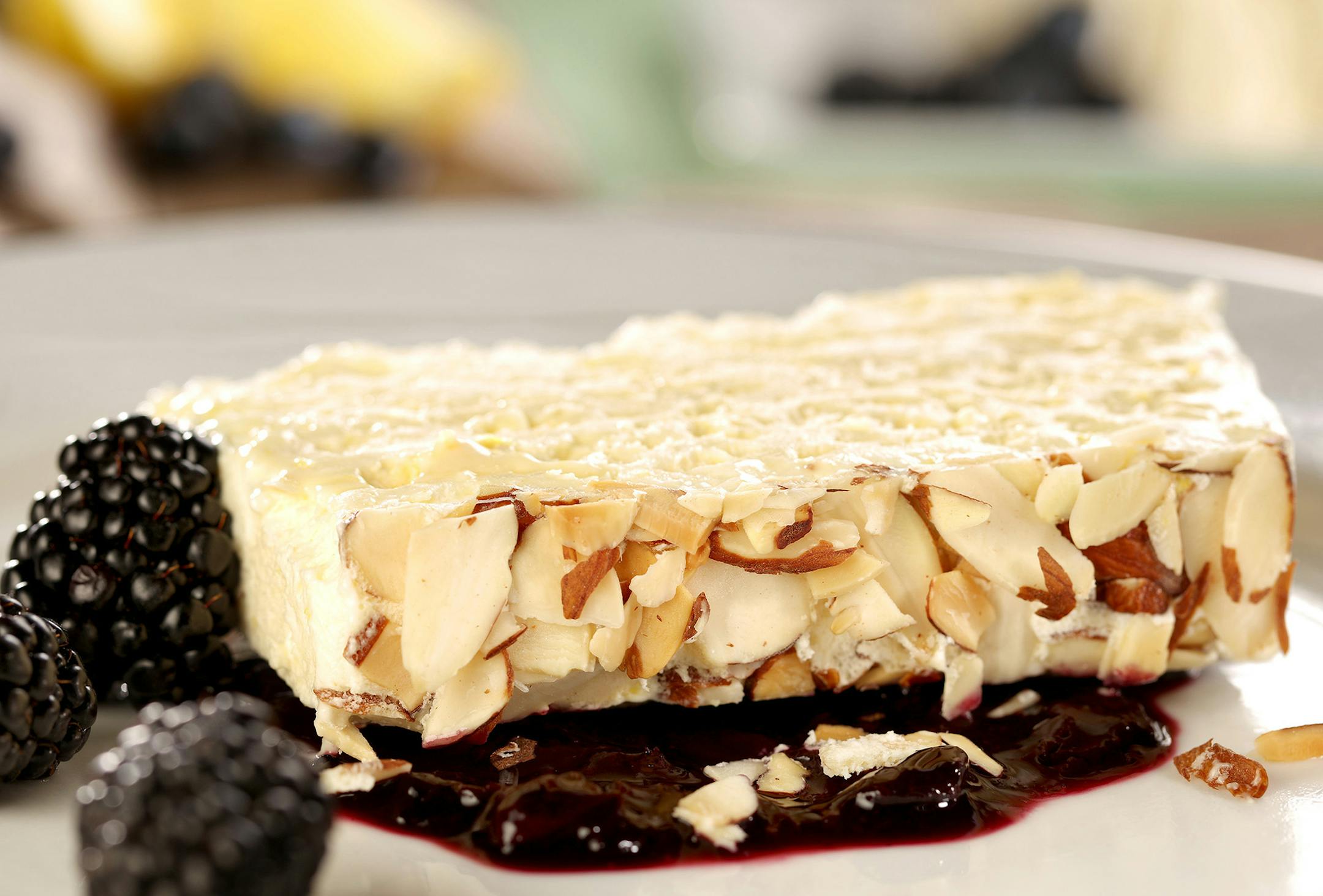 Fresh lemon juice and plenty of zest flavor a semifreddo served with a summer berry compote.