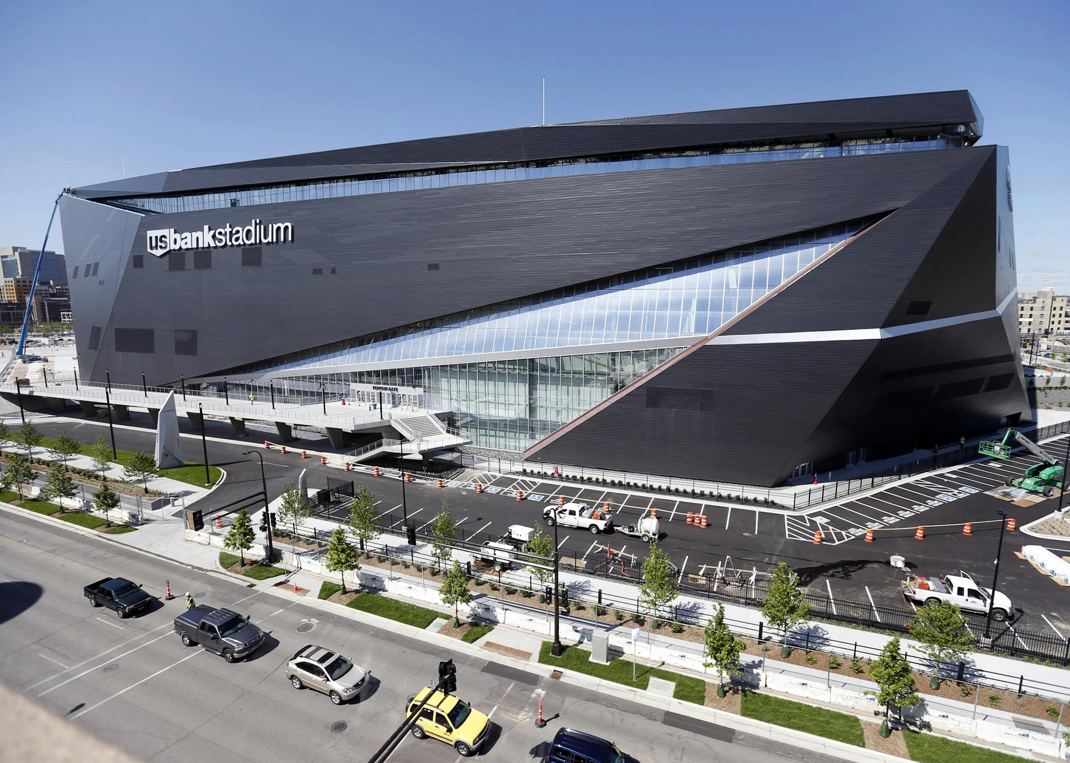 FILE - In this Thursday, June 2, 2016 file photo, finishing touches are made on U.S. Bank Stadium, the new home of the Minnesota Vikings NFL football team in Minneapolis. A judge on Thursday, June 23, 2016 ordered Wells Fargo to take down office-tower rooftop signs near the Minnesota Vikings' new stadium. U.S. District Judge Donovan Frank gave Wells Fargo 30 days to remove elevated signs from the rooftops of two office towers near U.S. Bank Stadium in downtown Minneapolis, (AP Photo/Jim Mone, Fi
