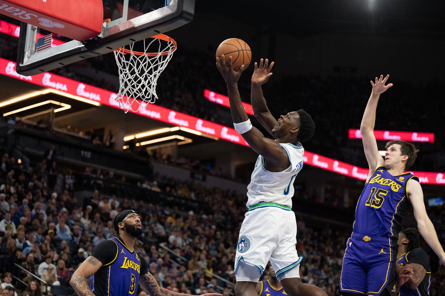 Minnesota Timberwolves guard Anthony Edwards (5) scored over Los Angeles Lakers guard Austin Reaves (15) in the first half Saturday December ,30, 2023 in, Minneapolis, Minn. ] JERRY HOLT • jerry.holt@startribune.com