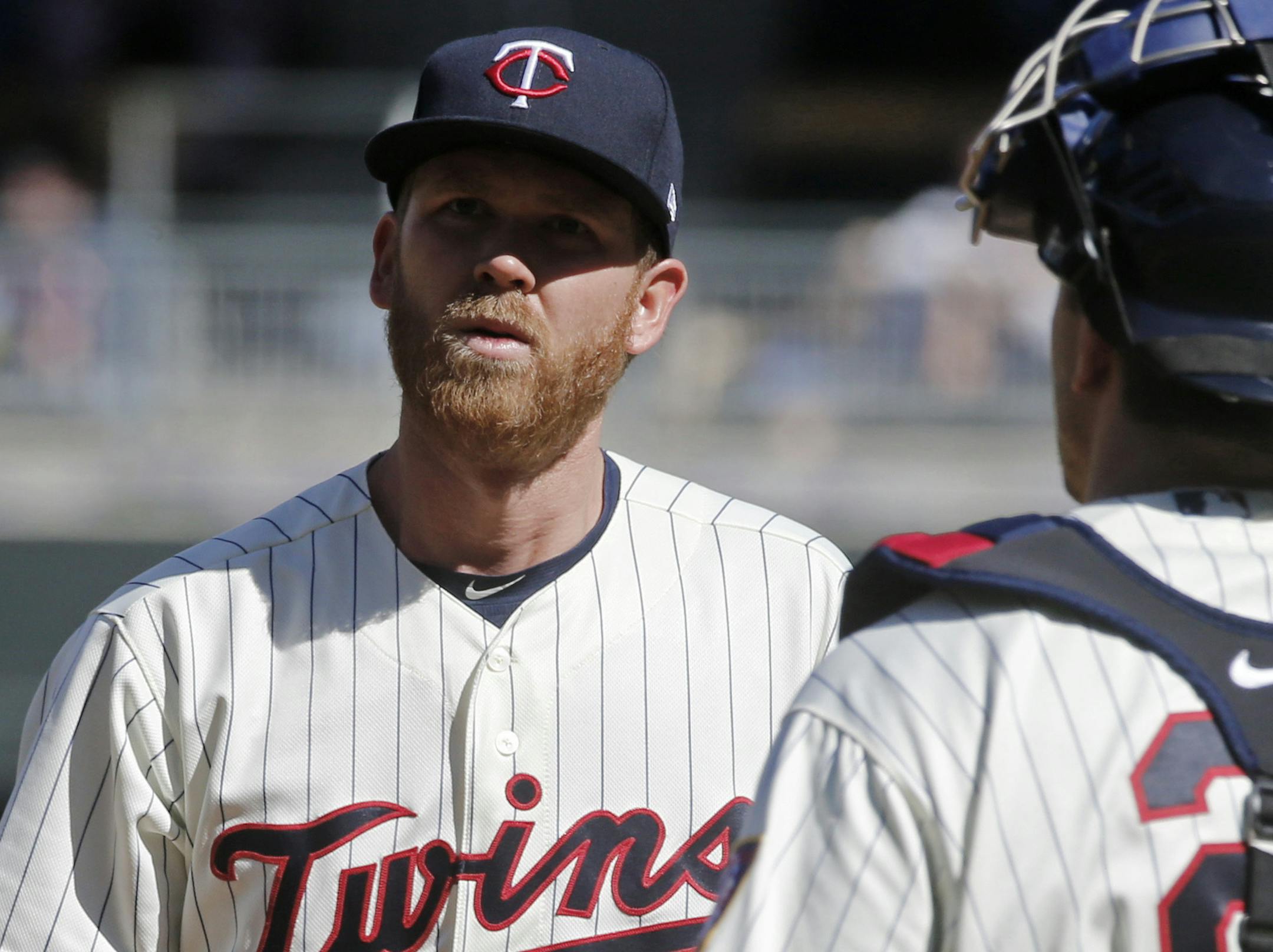 Minnesota Twins relief pitcher Michael Tonkin, left, gets a visit on the mount from catcher Jason Castro in the ninth inning of a baseball game Saturday, May 6, 2017, in Minneapolis. The Red Sox won 11-1. (AP Photo/Jim Mone)