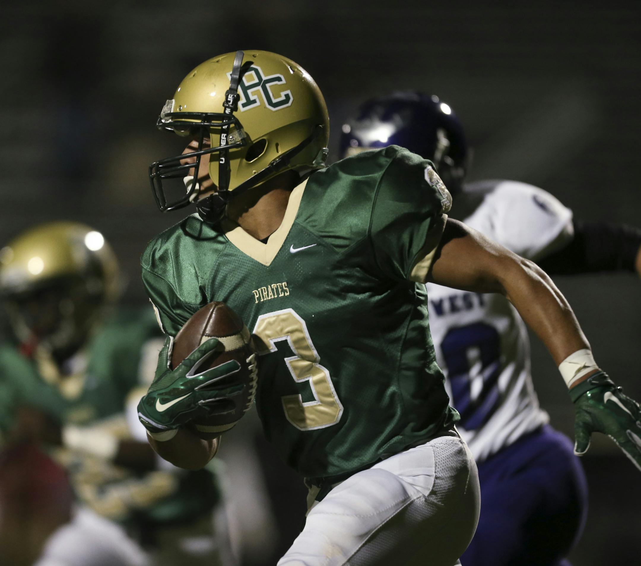 The Pirates' Amani Hooker ran in the first quarter on a keeper while playing quarterback Wednesday night at Park Center High School in Brooklyn Park. ] JEFF WHEELER ï jeff.wheeler@startribune.com The Park Center High School Pirates dominated the Minneapolis Southwest Lakers in a football Section 5AAAAA quarterfinal playoff game Wednesday night, October 14, 2015 in Brooklyn Park.