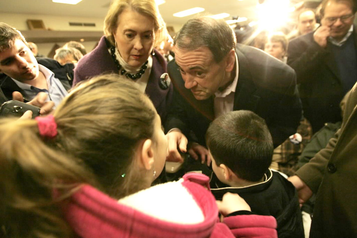 Presidential candidate Mike Huckabee greets supporters at the Veterans Memorial Building in Grinnell, Iowa, on Thursday.