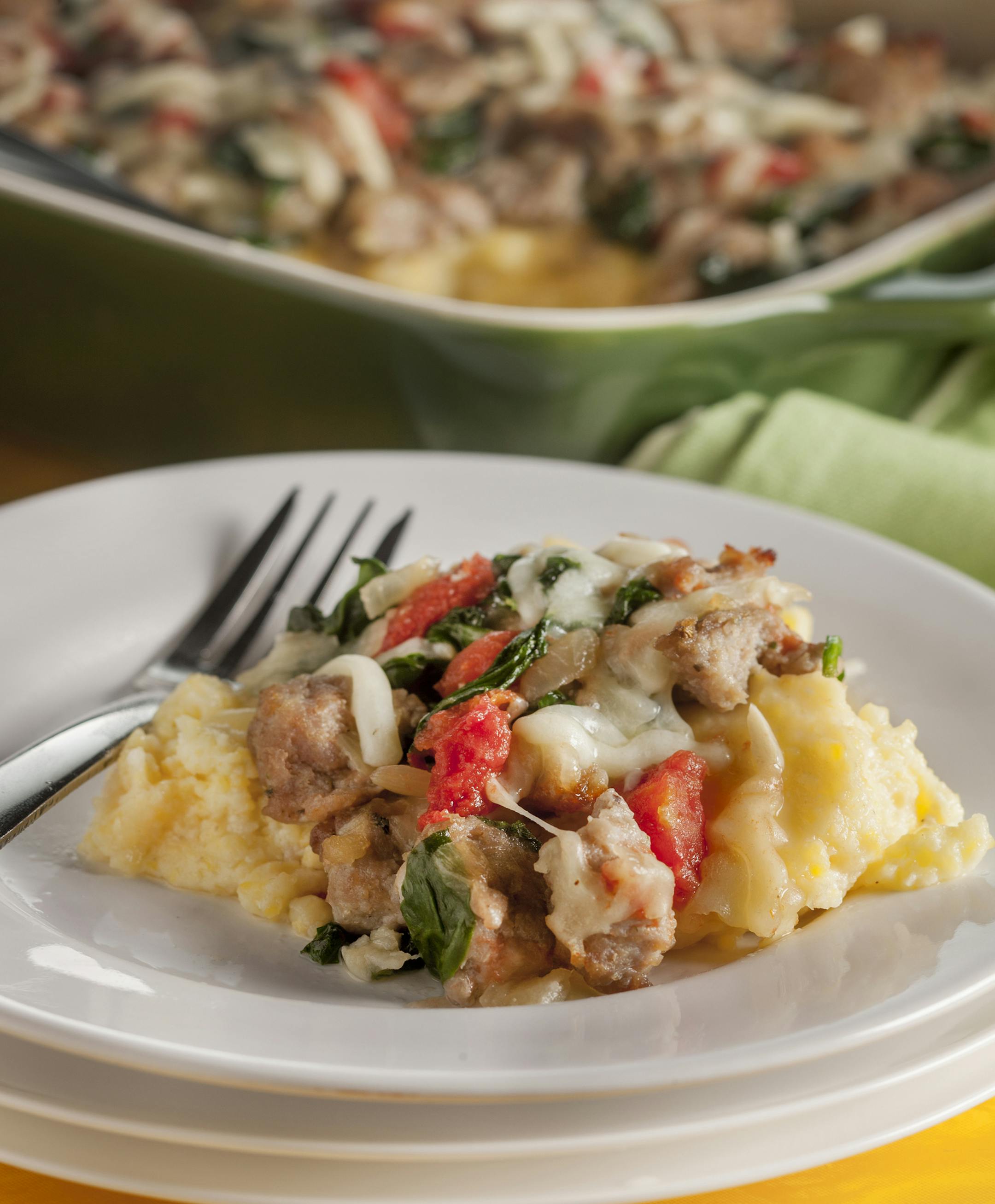 Italian sausage, tomatoes and lots of cheese top a polenta casserole from "The Make-Ahead Cook" by the editors at America's Test Kitchen. (Bill Hogan/Chicago Tribune/TNS) ORG XMIT: 1162956
