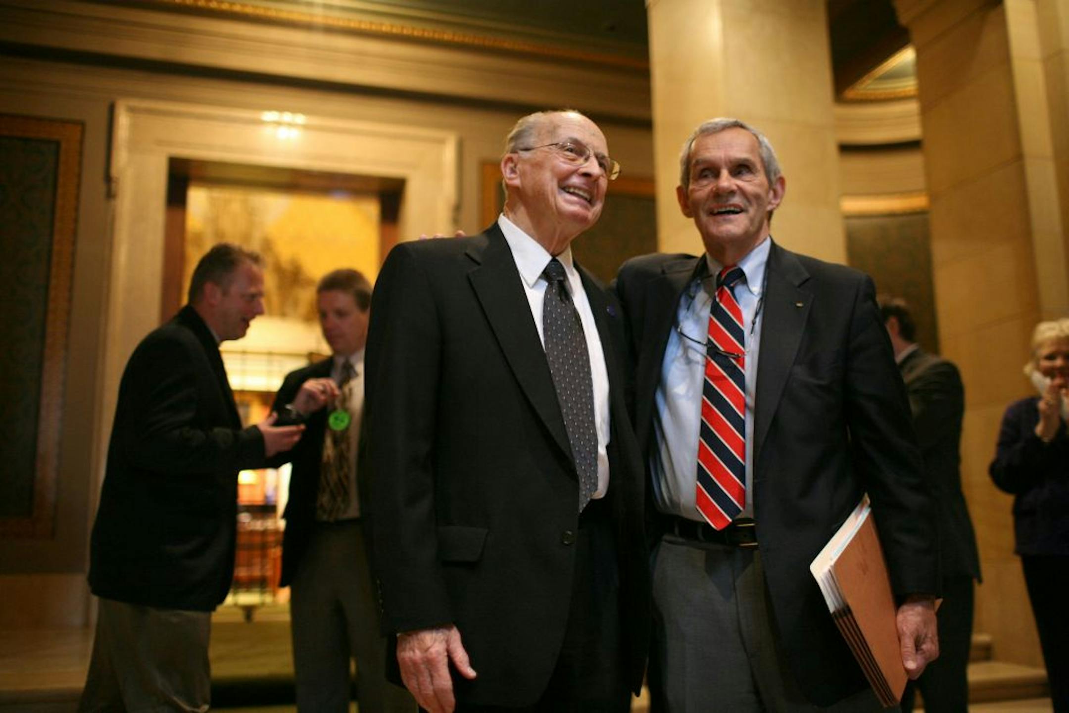 Representatives Bernie Lieder of Crookston, left, and Ron Erhardt of Edina after Erhardt broke from the Republican ranks and voted to override the governor's veto of the transportation funding bill Monday. Erhardt was stripped of his committee leadership by House Minority Leader Marty Seifert Tuesday as payback.