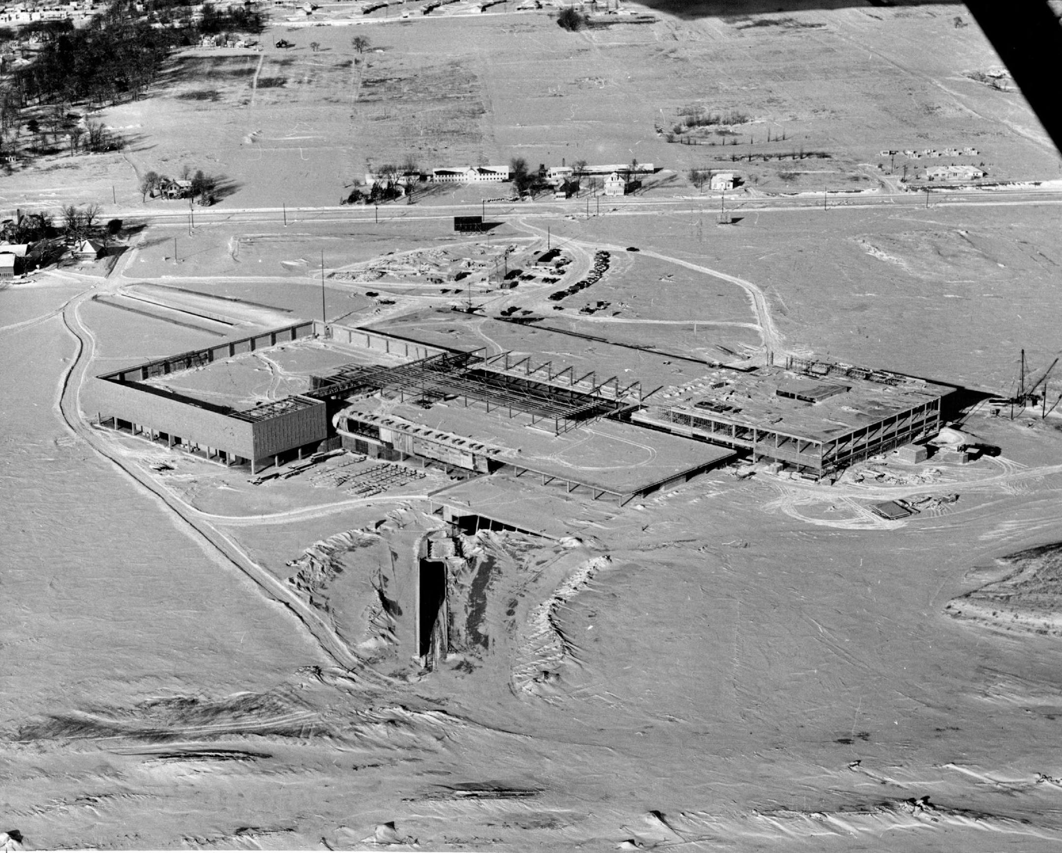January 11, 1955 Southdale Grows Construction of Southdale shopping center in Edina, shown in this recent aerial photograph,is progressing on schedule with completion planned for October of this year. The 10-million-dollar project will be the largest shopping center in the Twin Cities area. At the left is the building that will house a branch of Dayton's sponsor of the center. At right is the Donaldson's branch. The area between the two large stores will contain about 70 small shops and a roofed