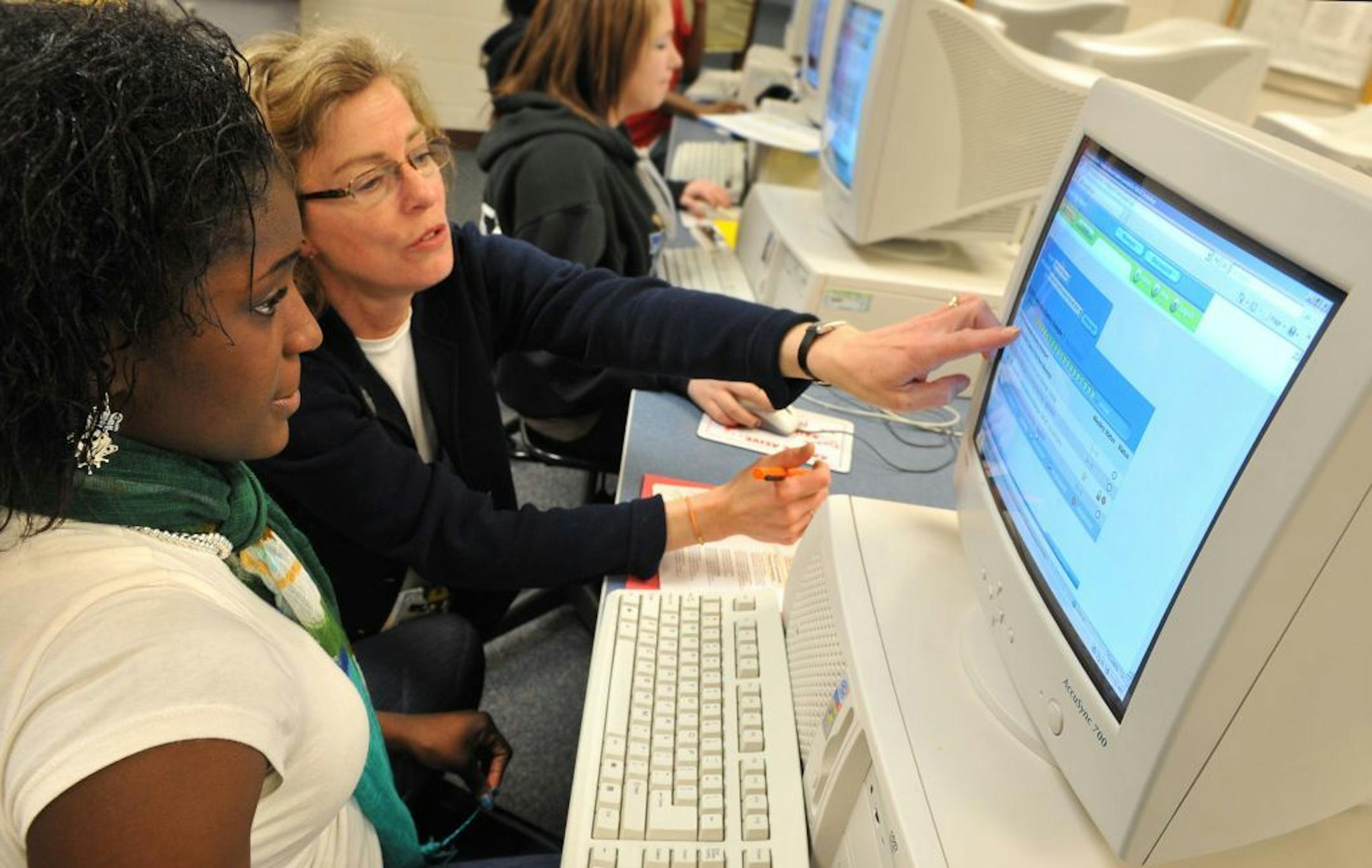 Reading specialist Nancy Stalland, right, started using Plato Learning software in her Tartan Senior High School reading skills class in March 2009.