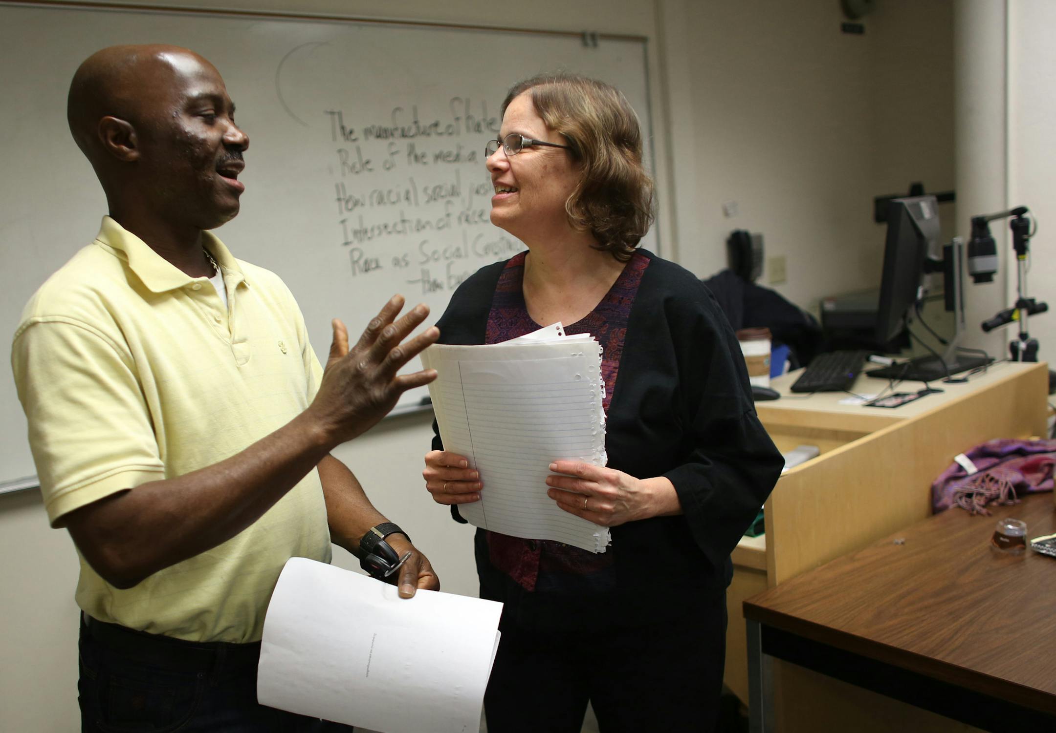 Student James David laughed with professor Anne Winkler-Morey as they talked about the assignment she just handed back to him right before class. ] (KYNDELL HARKNESS/STAR TRIBUNE) kyndell.harkness@startribune.com Anne Winkler-Morey teaches as an adjunct professor at Metro State University in Minneapolis, MN Wednesday, March 5, 2014.