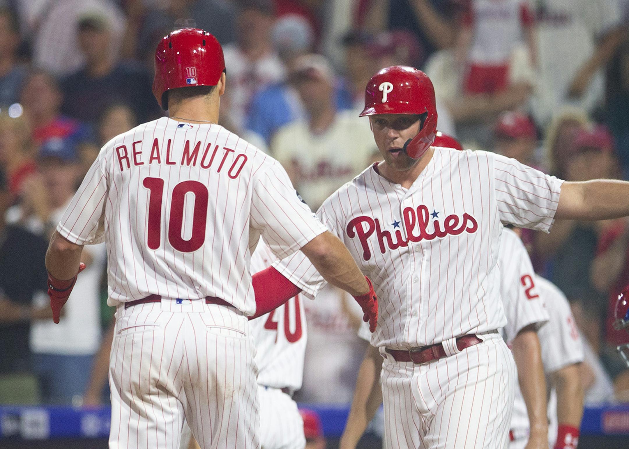 J.T. Realmuto of the Philadelphia Phillies celebrates with Rhys Hoskins (17) after hitting a grand slam in the third inning against the Chicago Cubs at Citizens Bank Park in Philadelphia on Wednesday, Aug. 14, 2019. The Phillies won, 11-1. (Mitchell Leff/Getty Images/TNS) **FOR USE WITH THIS STORY ONLY**