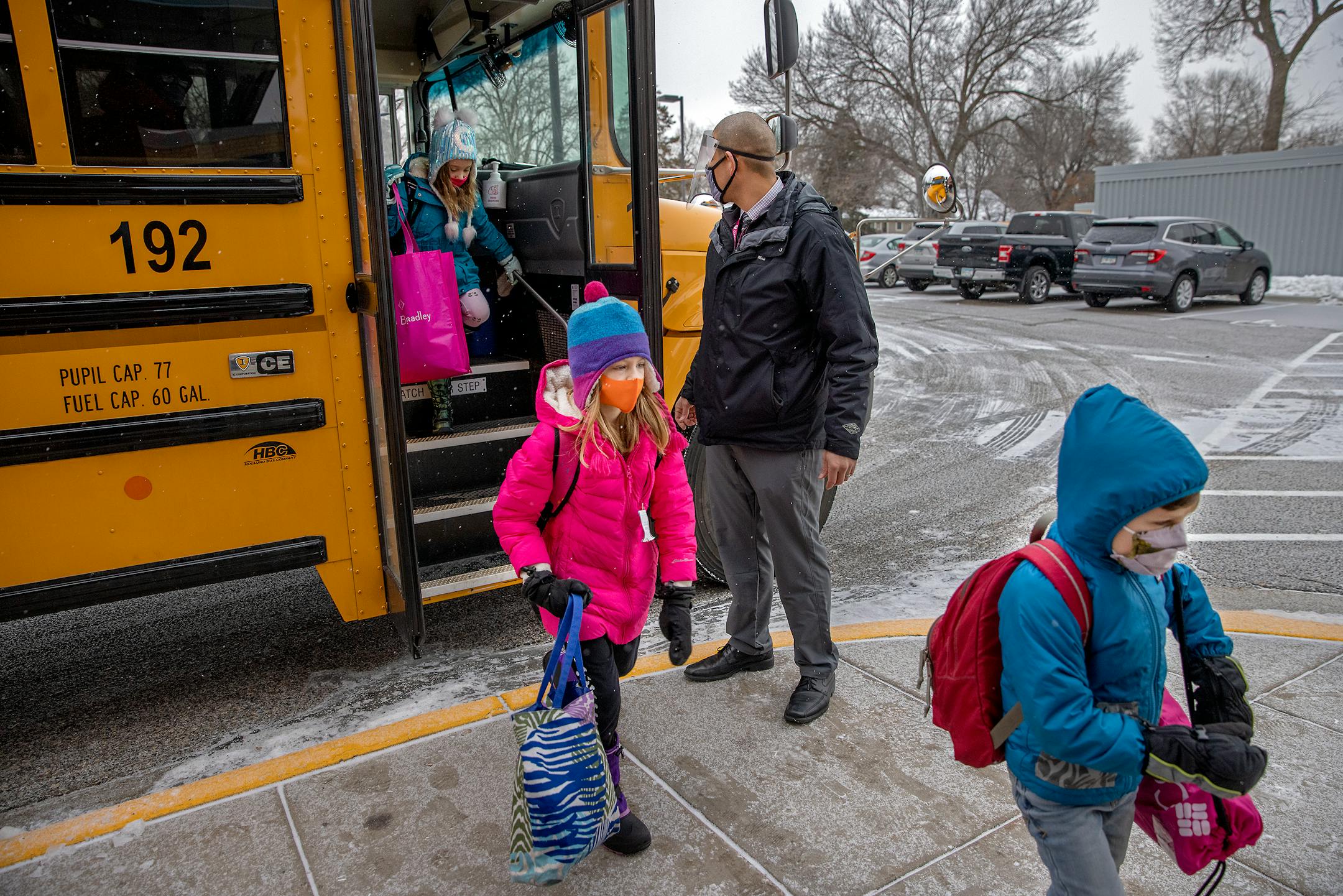Poplar Elementary School Principal Roberto Cantu welcomed students as they came off the bus for the first day of full in person instruction, Tuesday, January 19, 2021 in Bloomington, MN.
